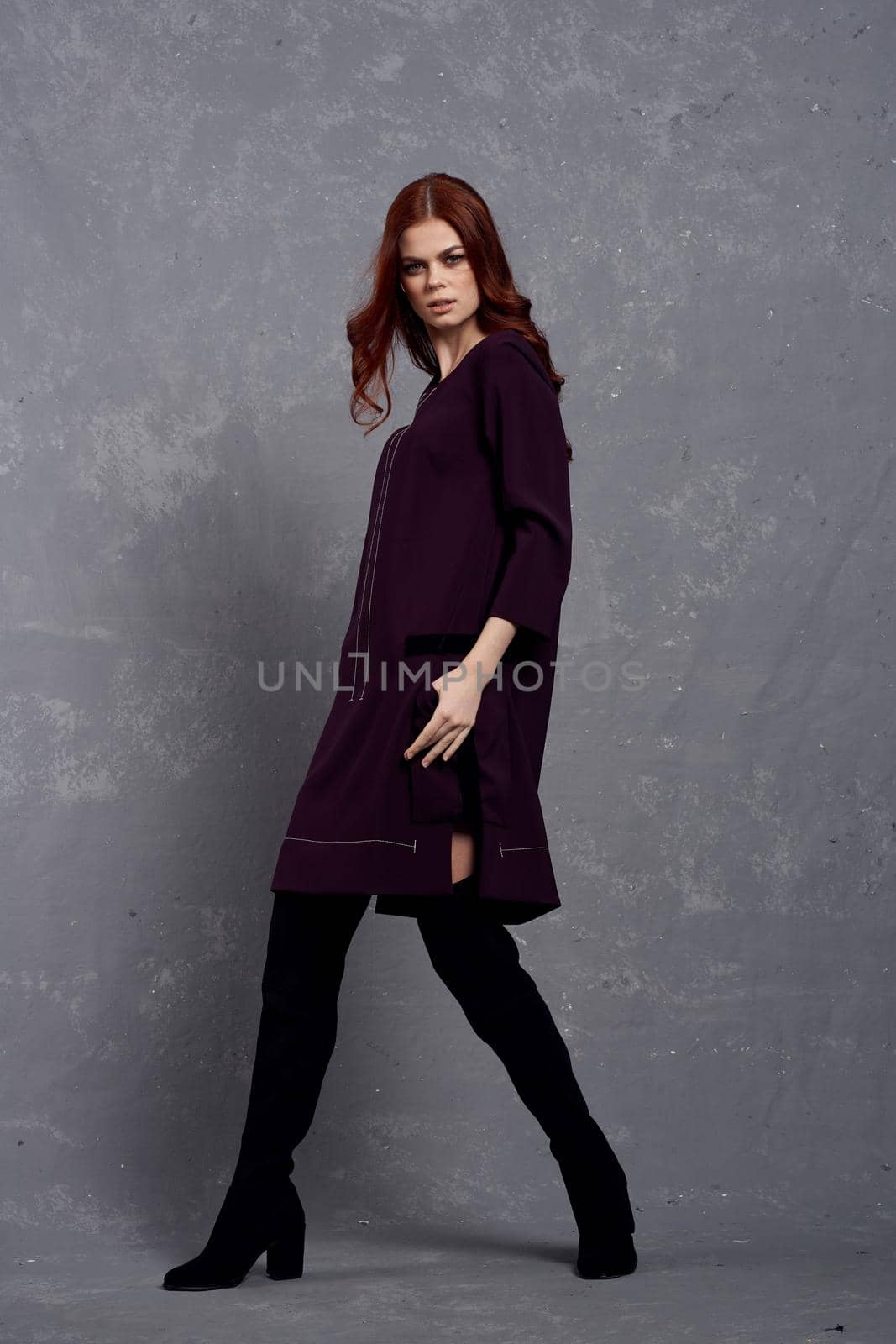 woman in fashionable clothes in full length posing in studio glamor. High quality photo