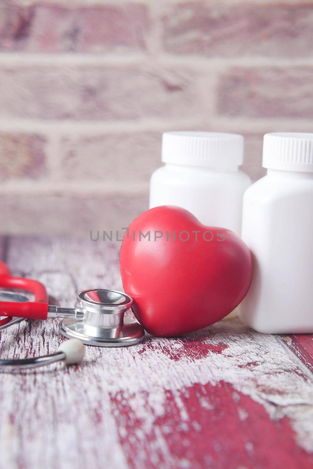 heart shape symbol and stethoscope on table .