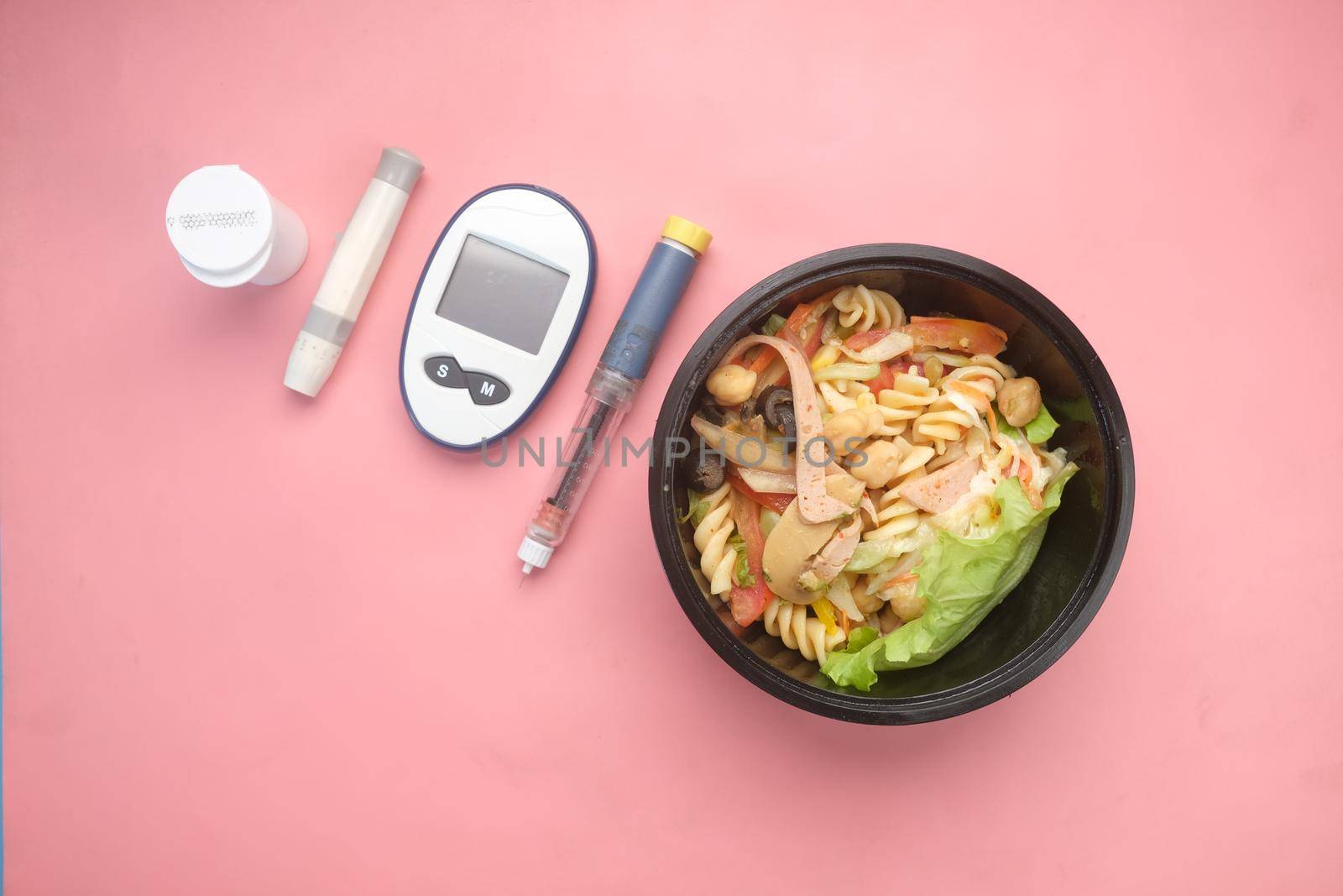 diabetic measurement tools and insulin pen on table .