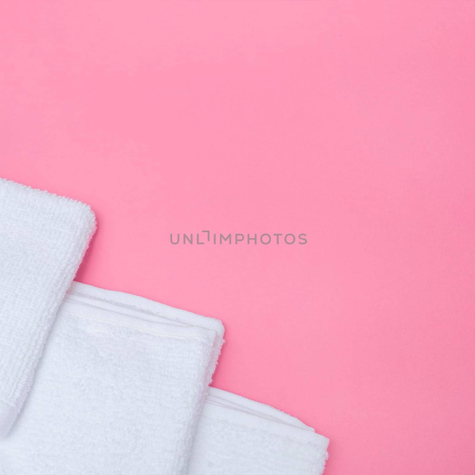 high angle view white towels pink background. High quality photo by Zahard