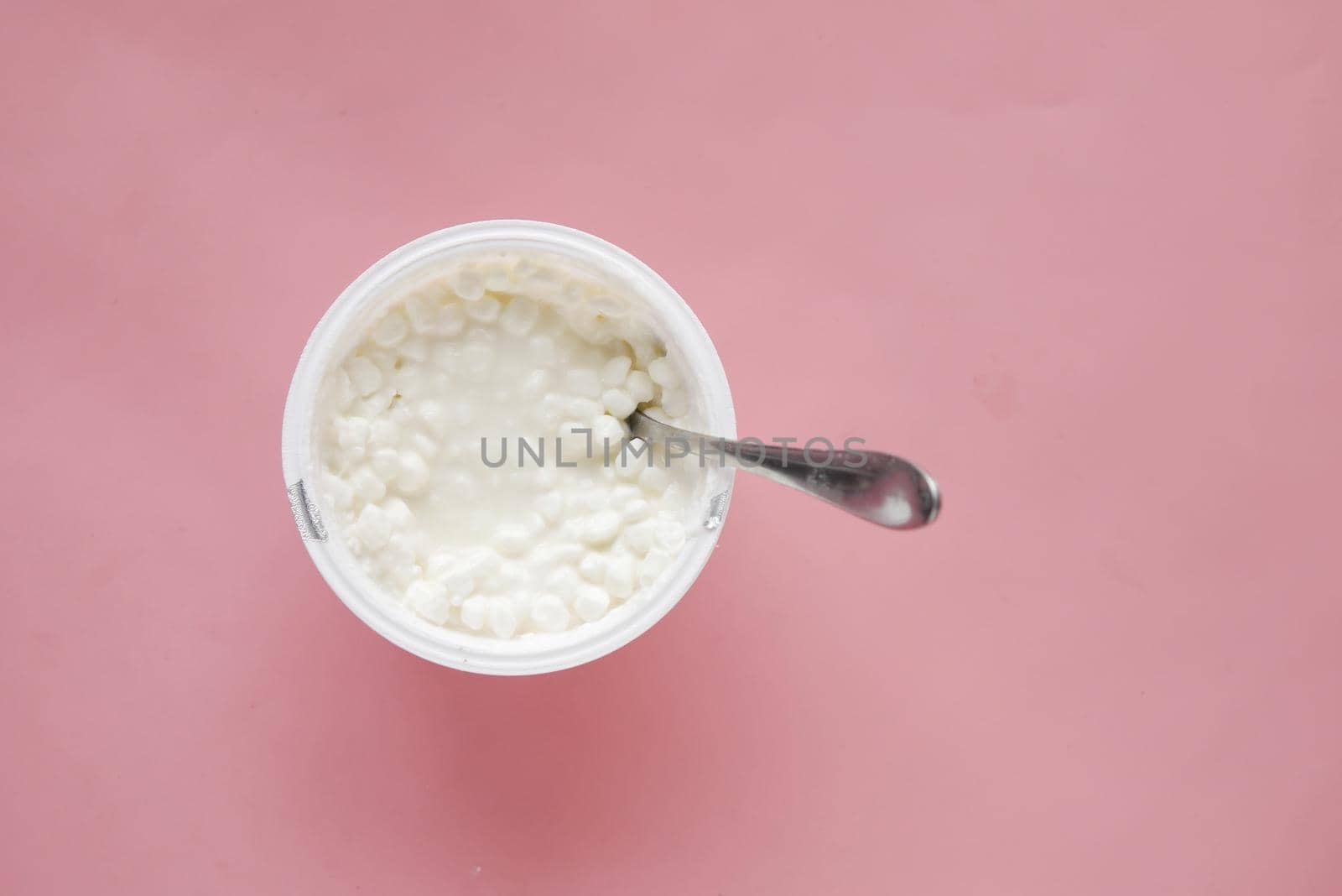 cottage cheese in a bowl on pink background .