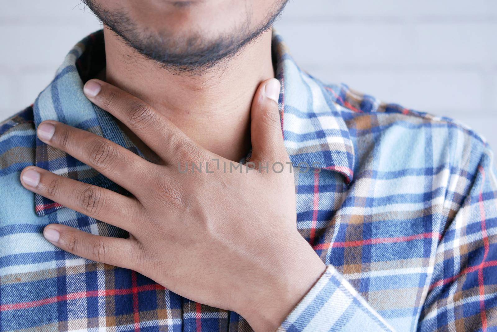 unrecognized man suffering throat pain close up .