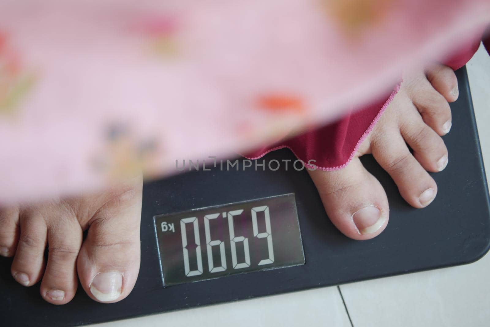 woman's feet on weight scale close up