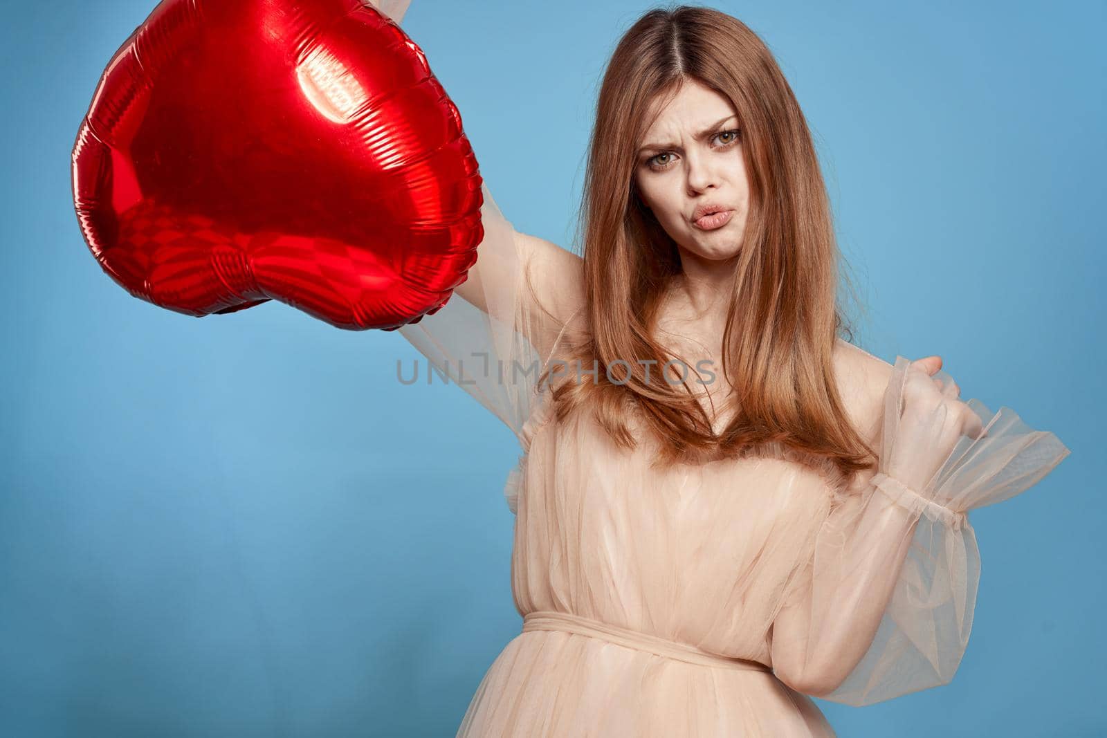 beautiful woman red heart in the hands of the balloon isolated background. High quality photo