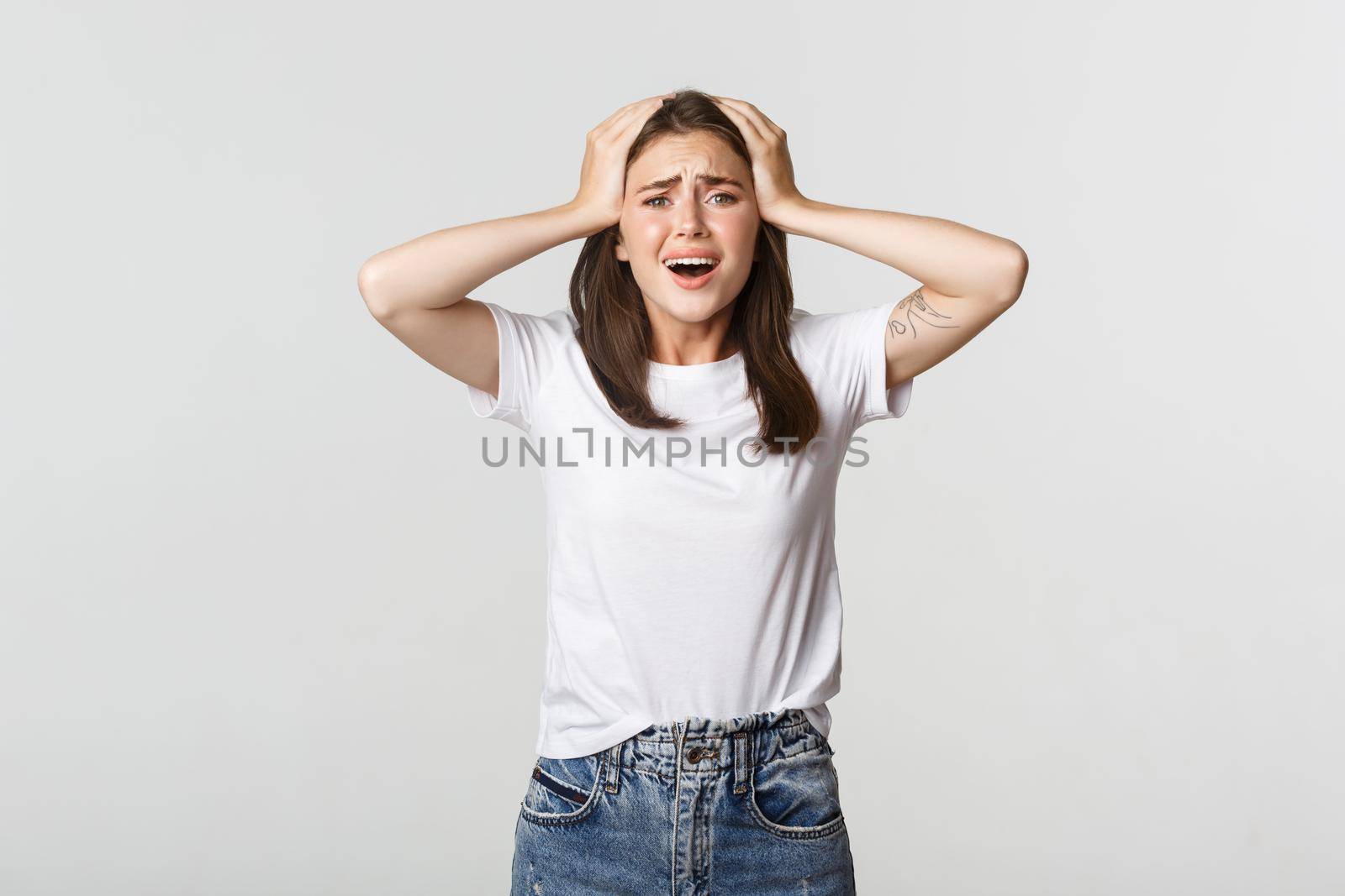 Miserable and shocked young girl panicking, looking alarmed.