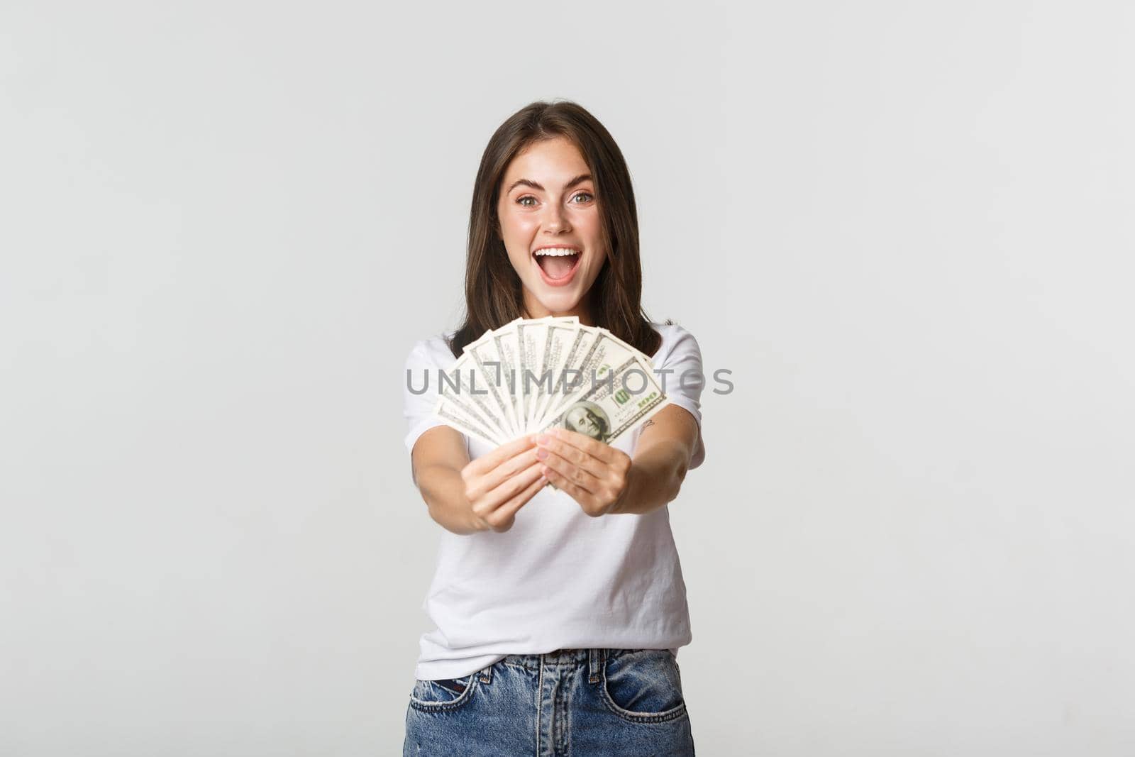 Smiling beautiful girl giving you money, congratulating with win.