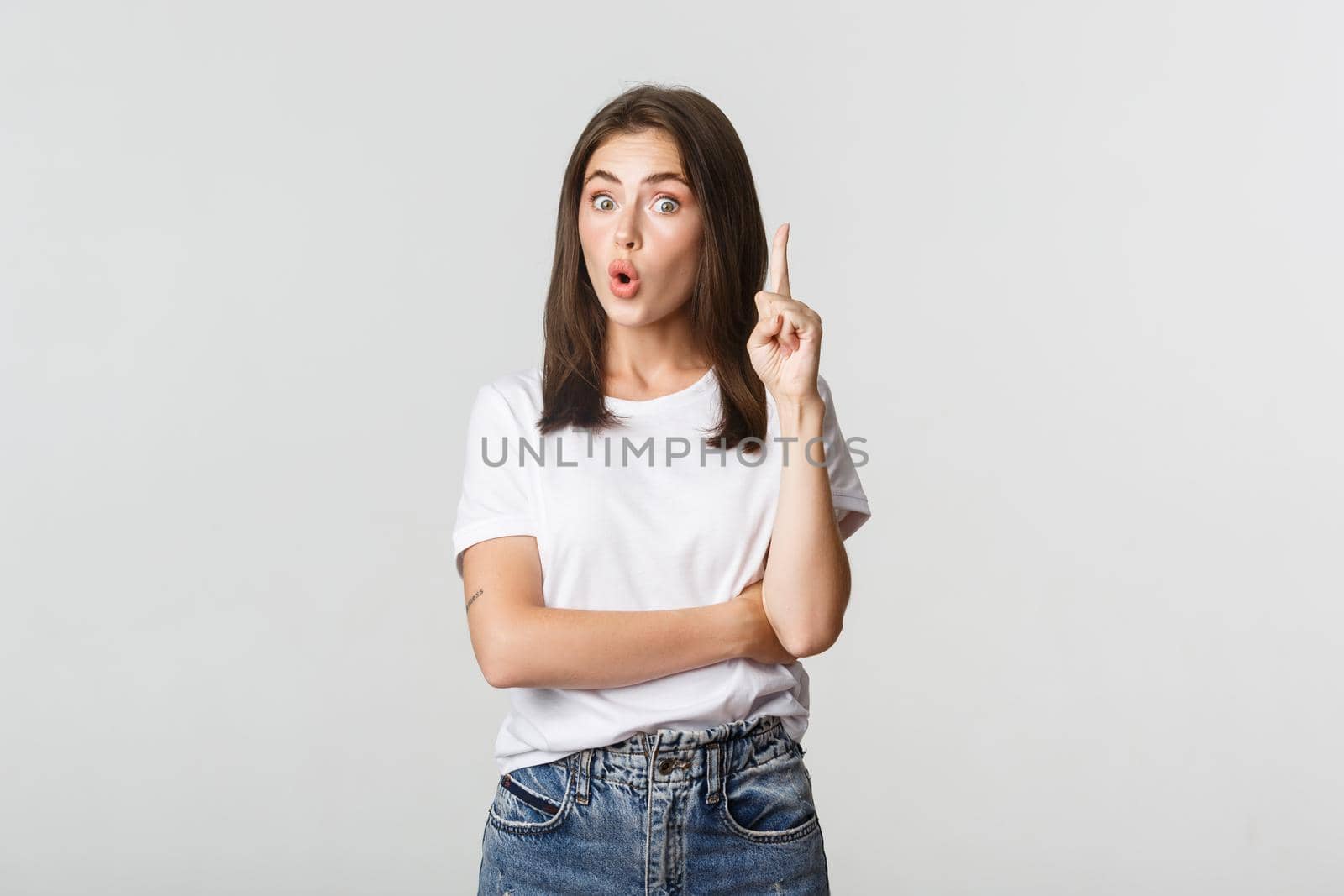 Portrait of excited girl raising finger, have suggestion or thought.