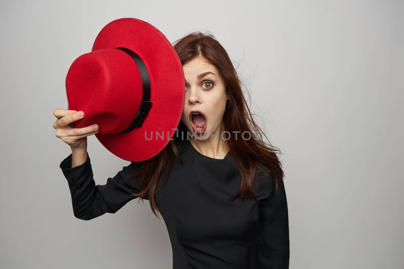 woman in black dress red hat witch emotions. High quality photo