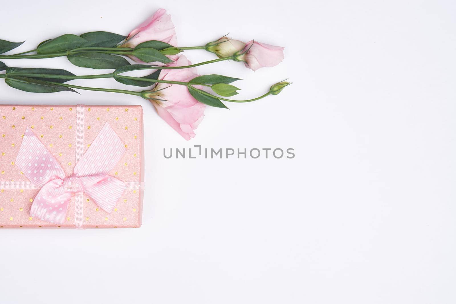 pink gift box flower bouquet holiday light background. High quality photo