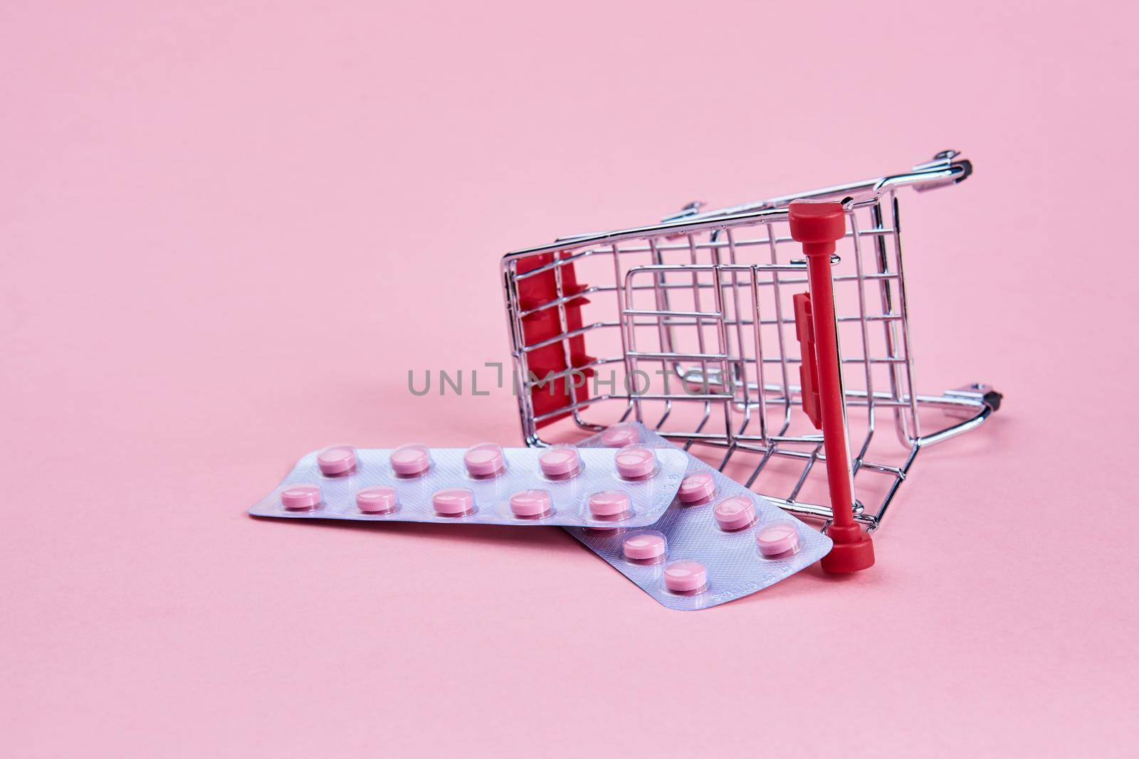 small cart with a pack of drugs pharmacy shopping service medicine. High quality photo