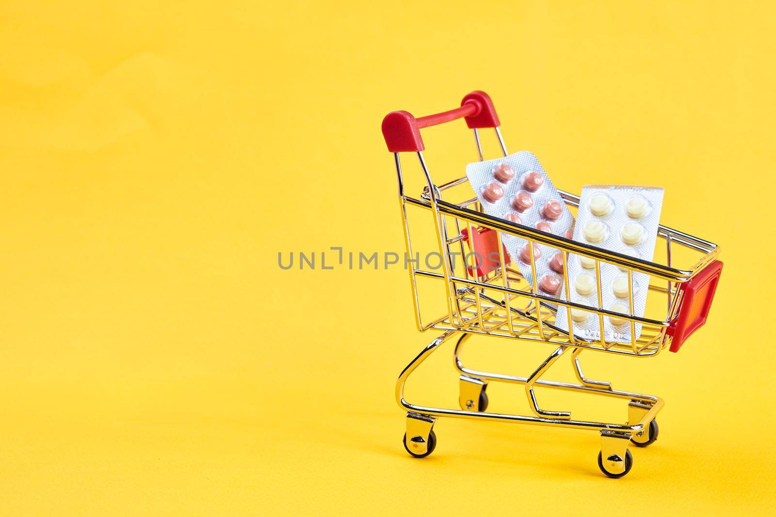 drug trolleys service delivery shopping pharmacy yellow background. High quality photo