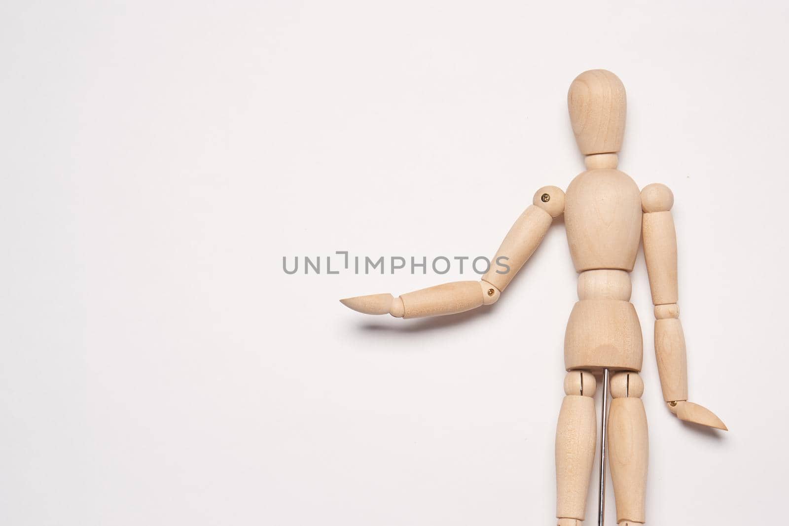 wooden man mannequin posing object light background. High quality photo