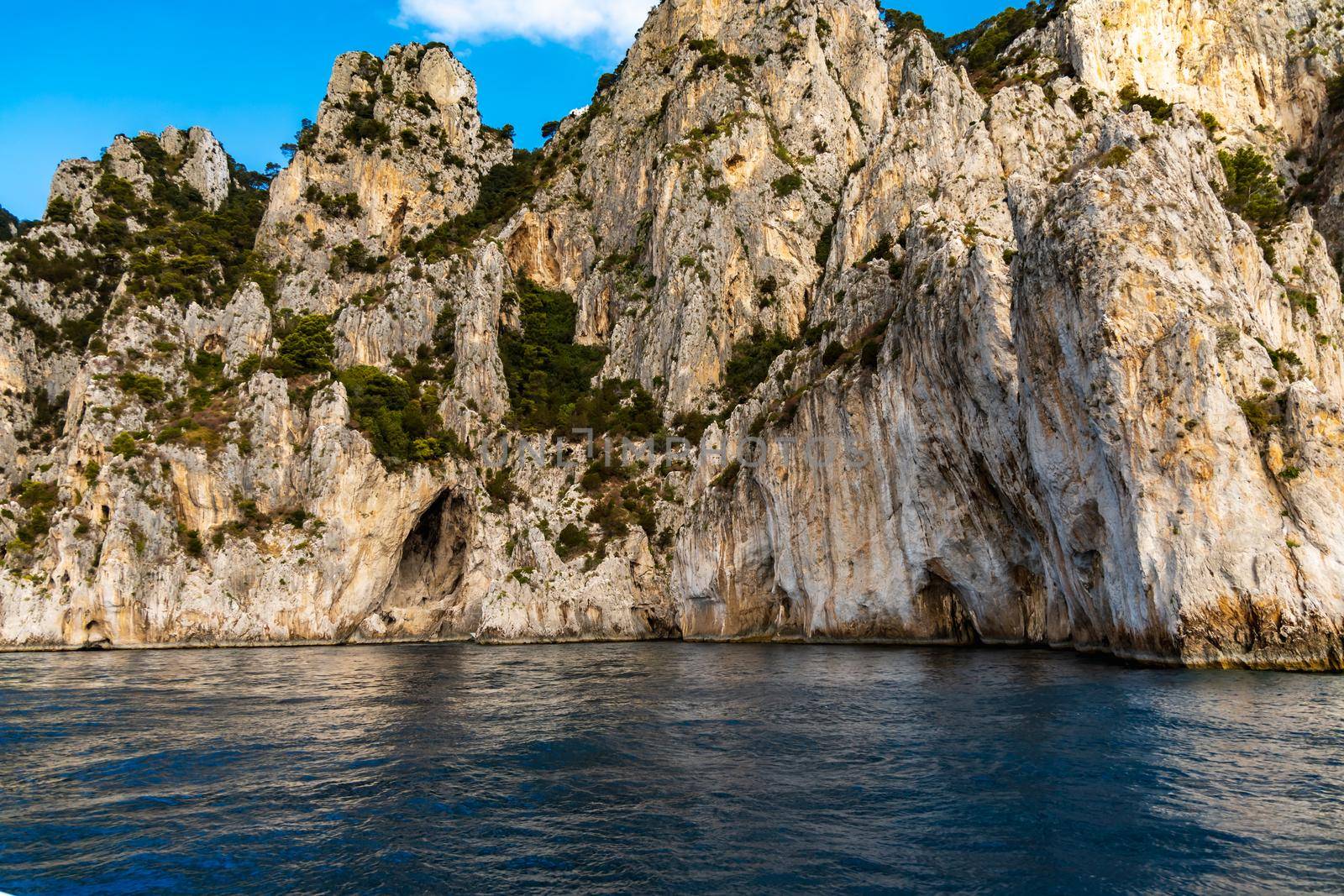 Edge of high cliff next to the sea at sunny day on Capri island by Wierzchu