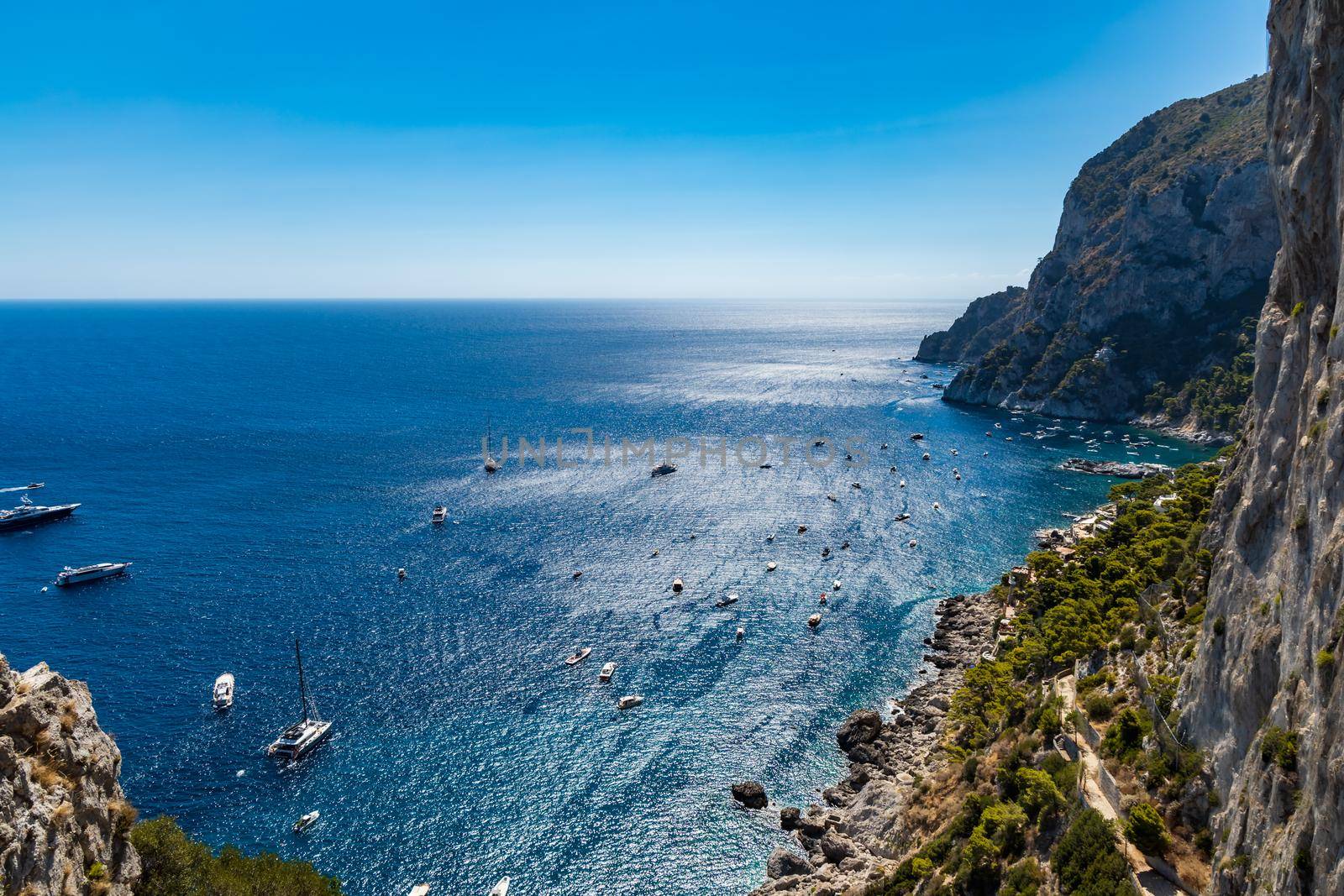 Beautiful panorama of small bay full of small ships and boats next to Capri island  by Wierzchu