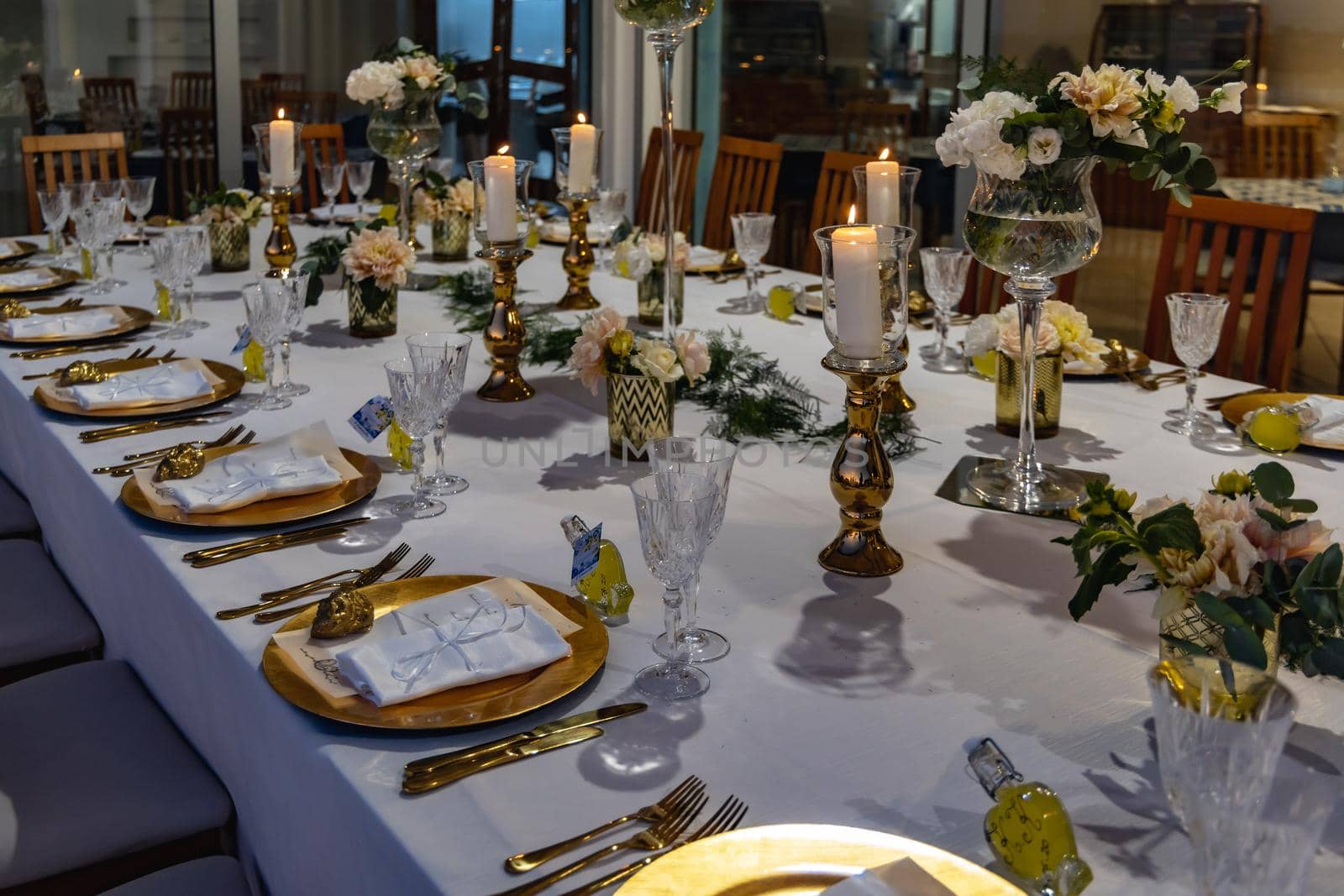 White green and golden decorations on wedding table at outdoor wedding