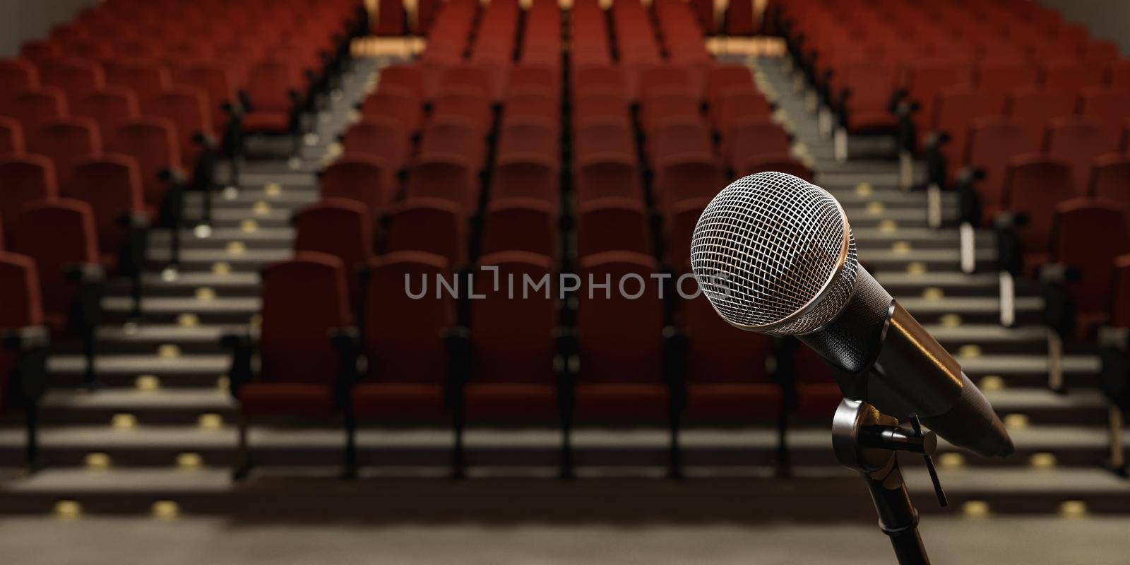 closeup of microphone in a theater with blurred seats by asolano