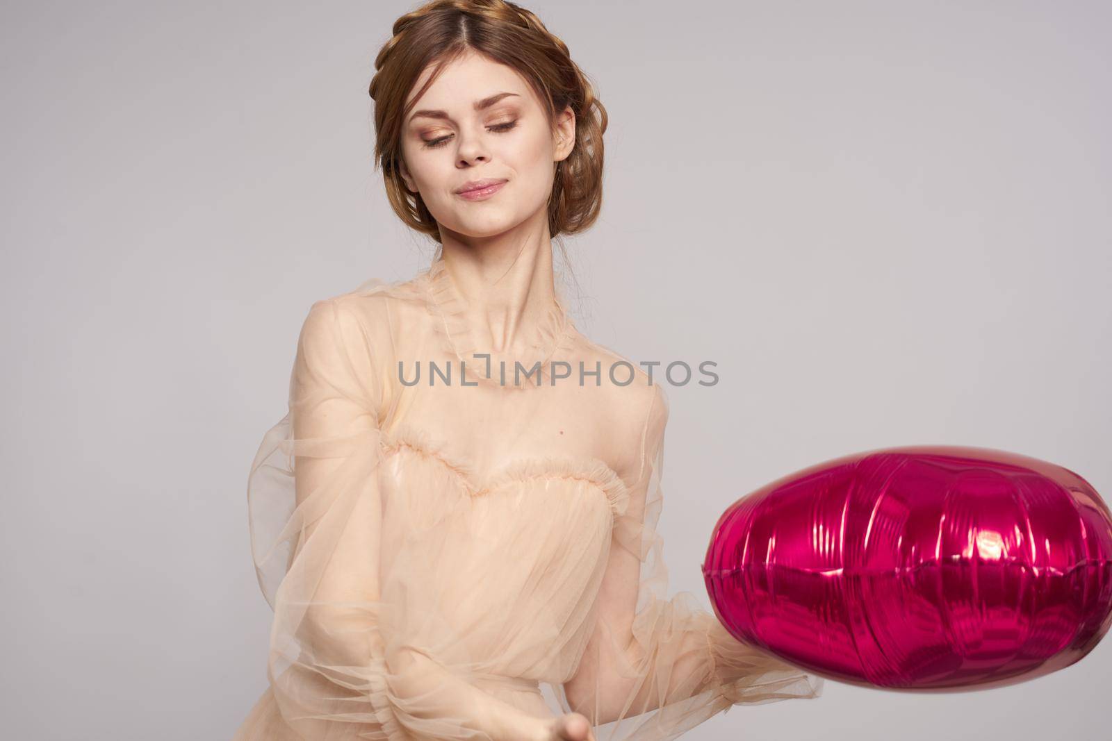 cheerful woman in a dress balloon Valentine's Day isolated background. High quality photo