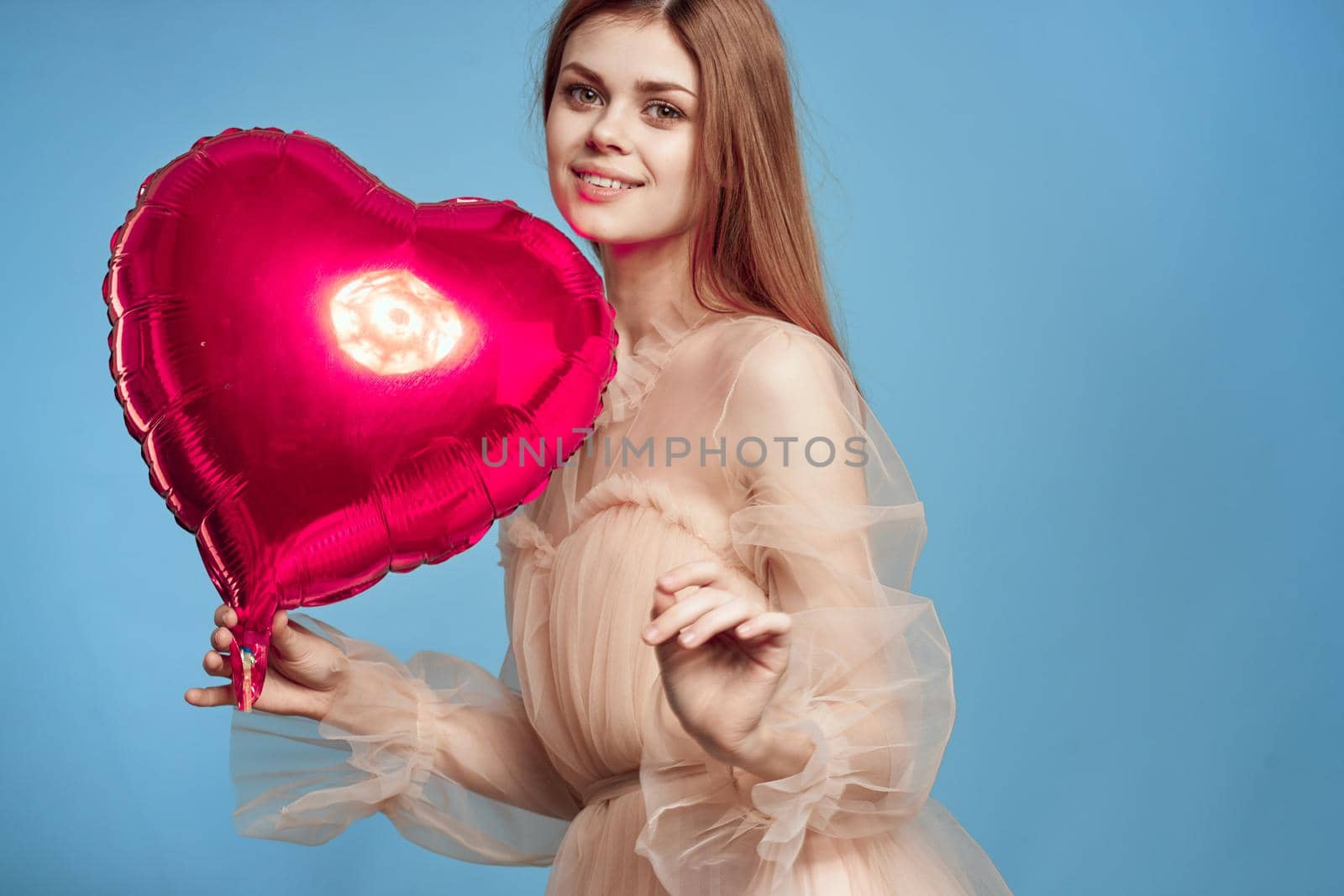 beautiful woman red heart in the hands of the balloon blue background by Vichizh