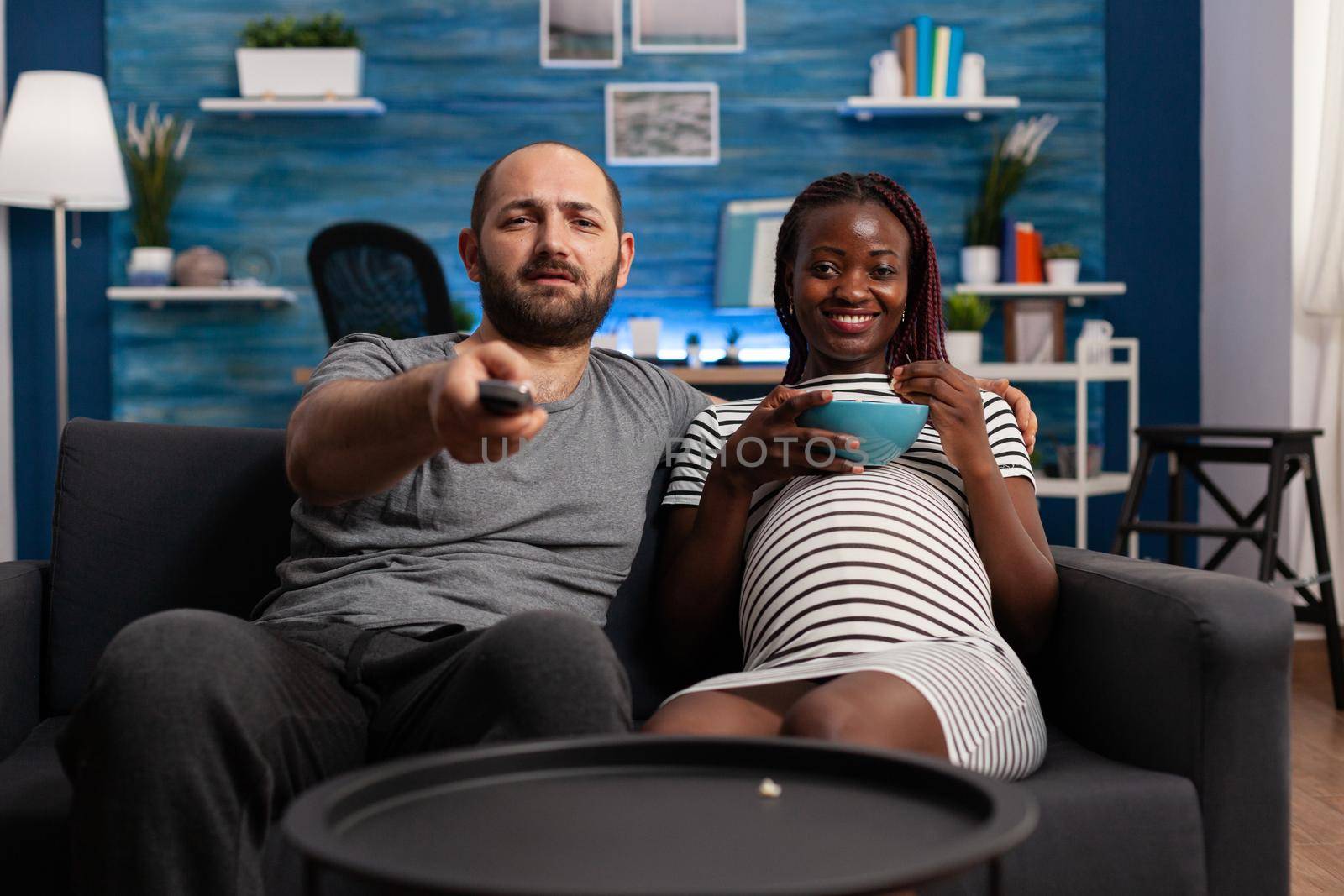 POV of pregnant interracial people looking at camera by DCStudio