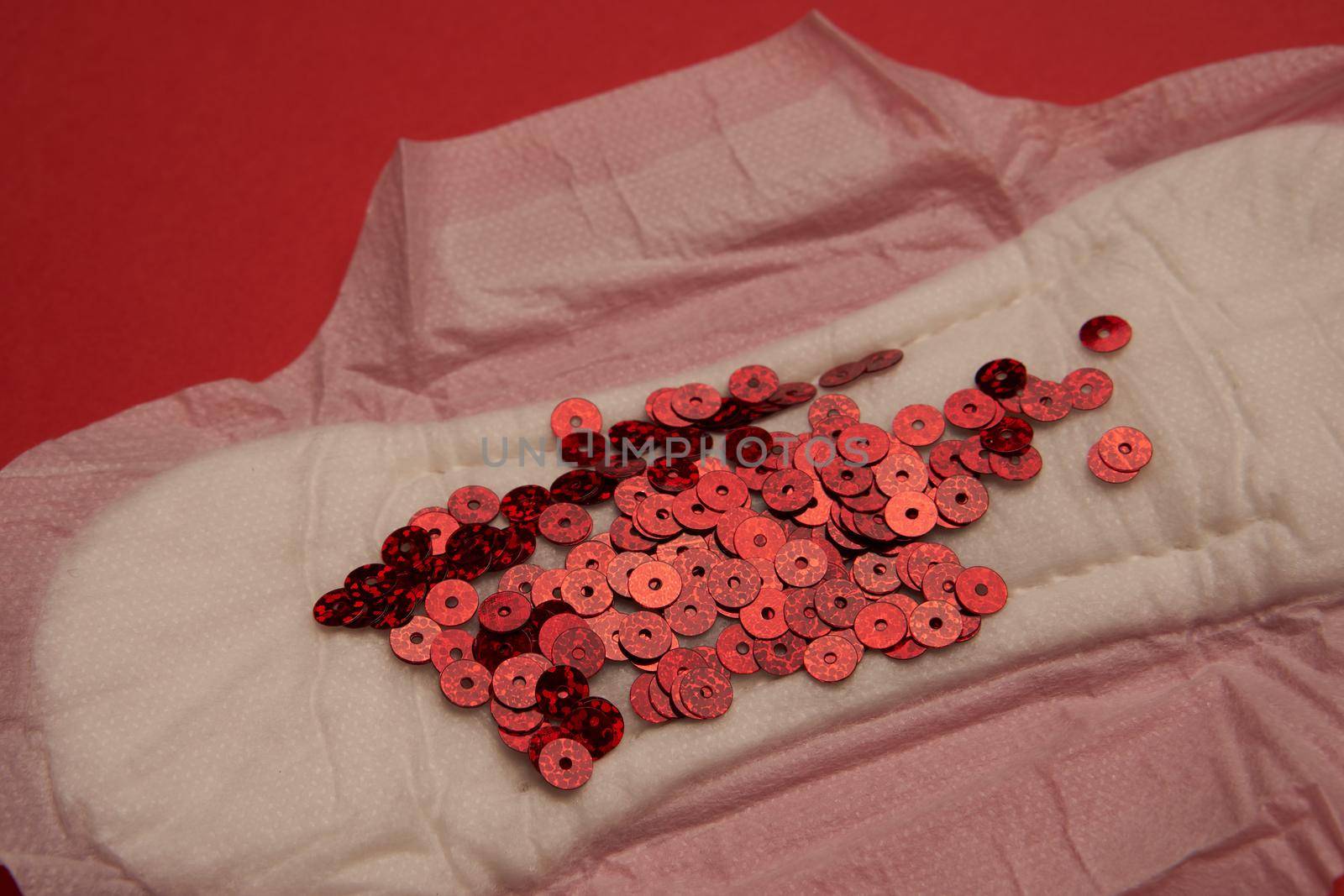 feminine pad blood menstruation hygiene red background. High quality photo