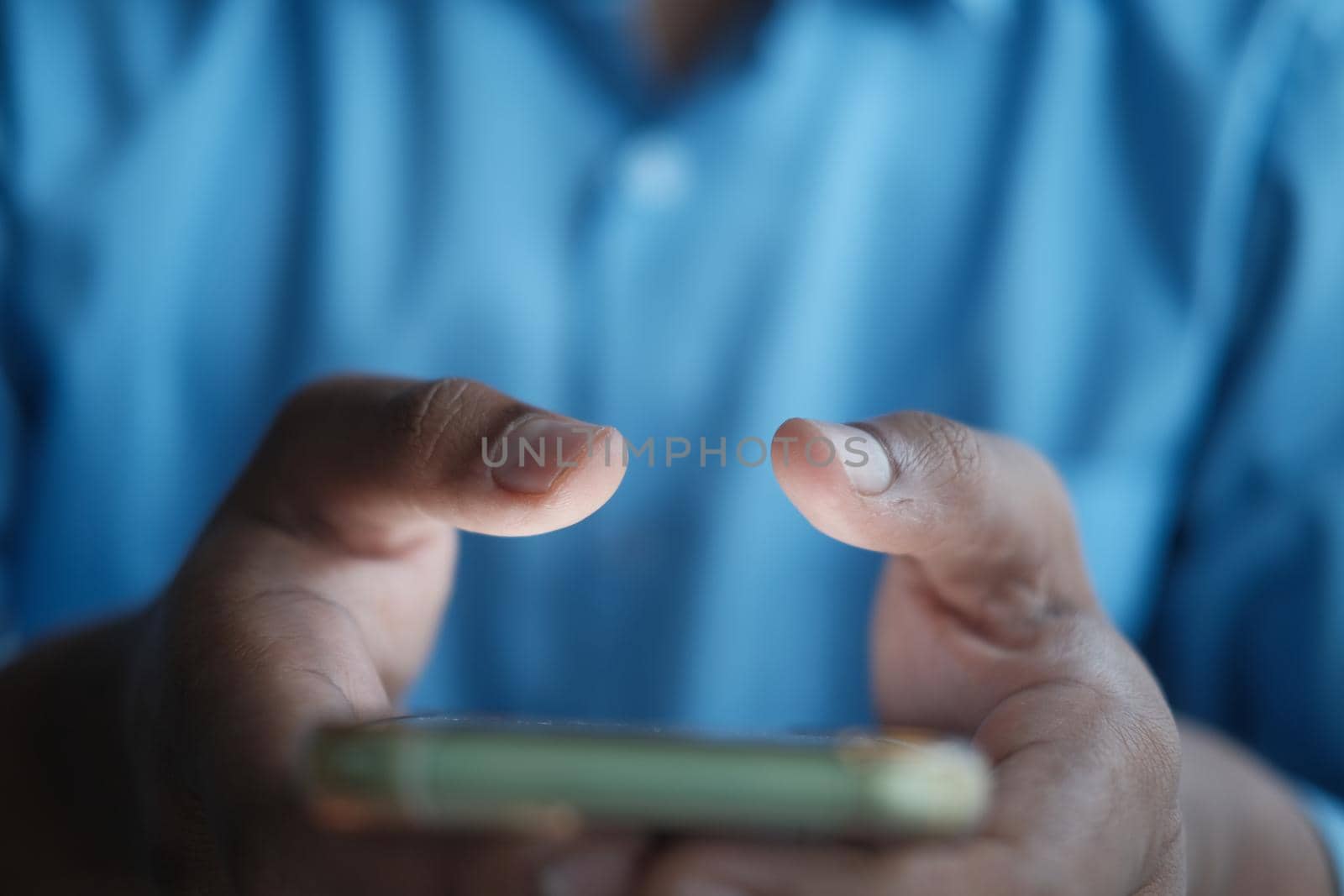 Close up of young man hand using smart phone