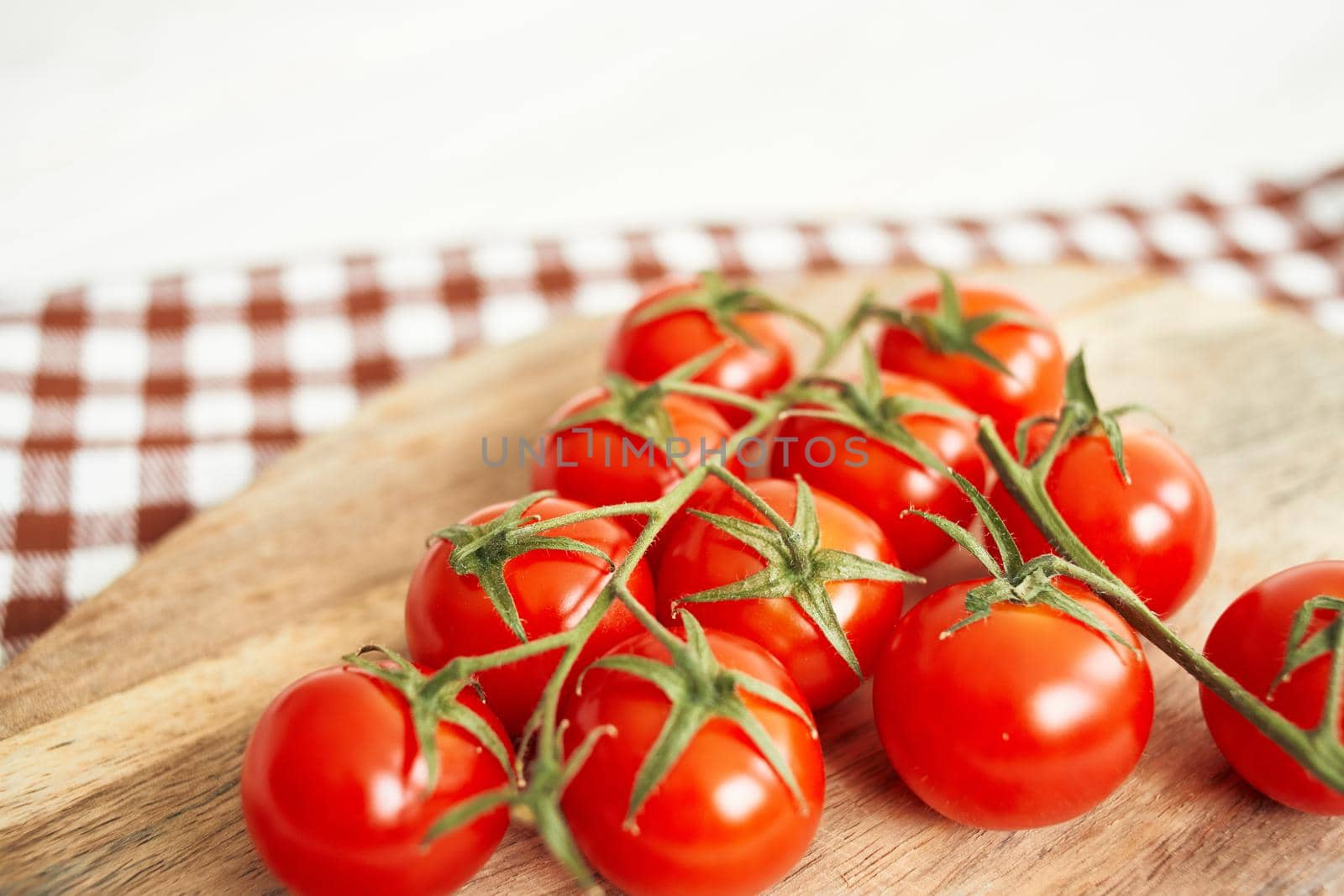 food Cherry tomatoes on a cutting board wood background. High quality photo