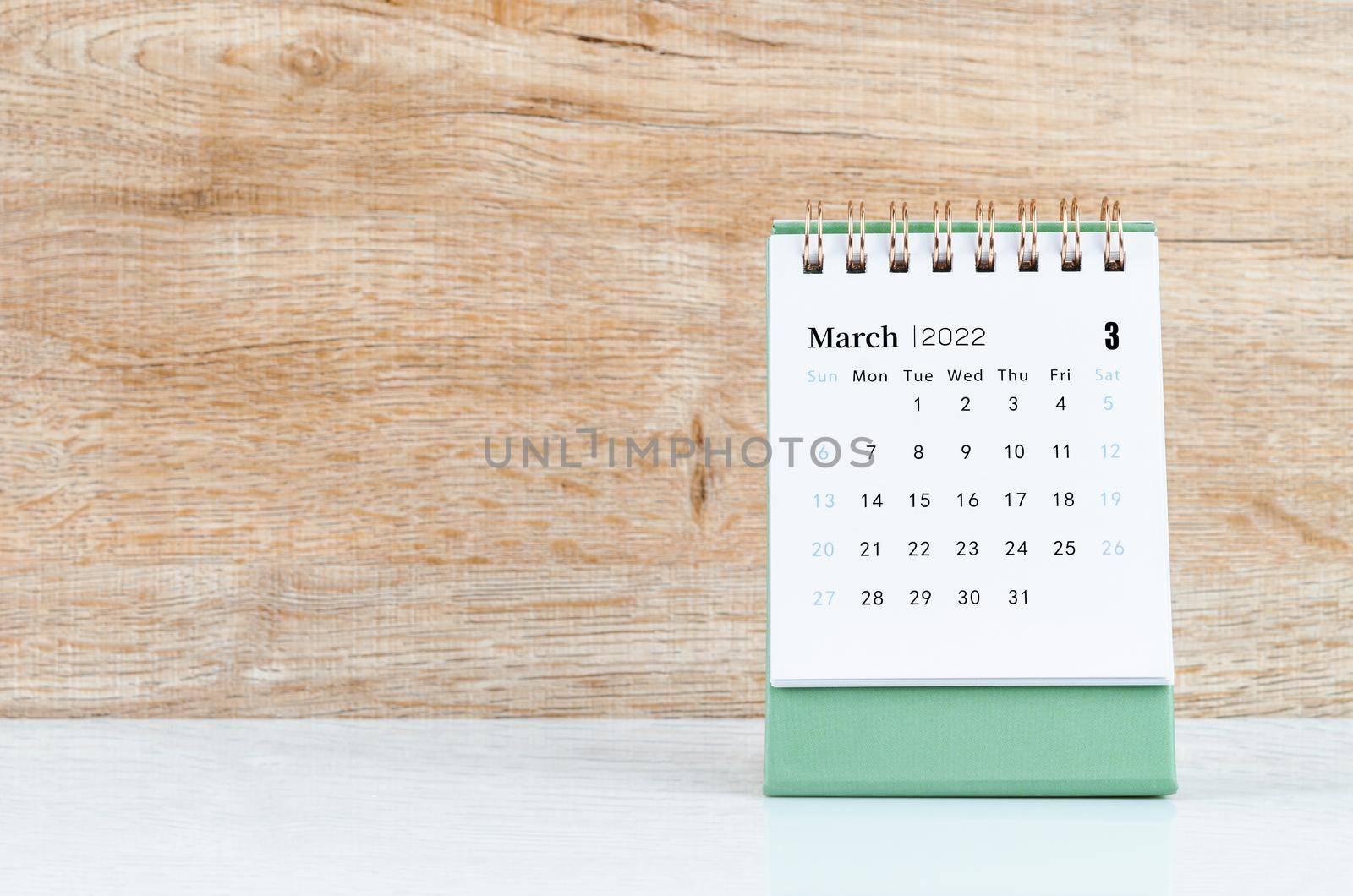 The March calendar 2022 on wooden background.