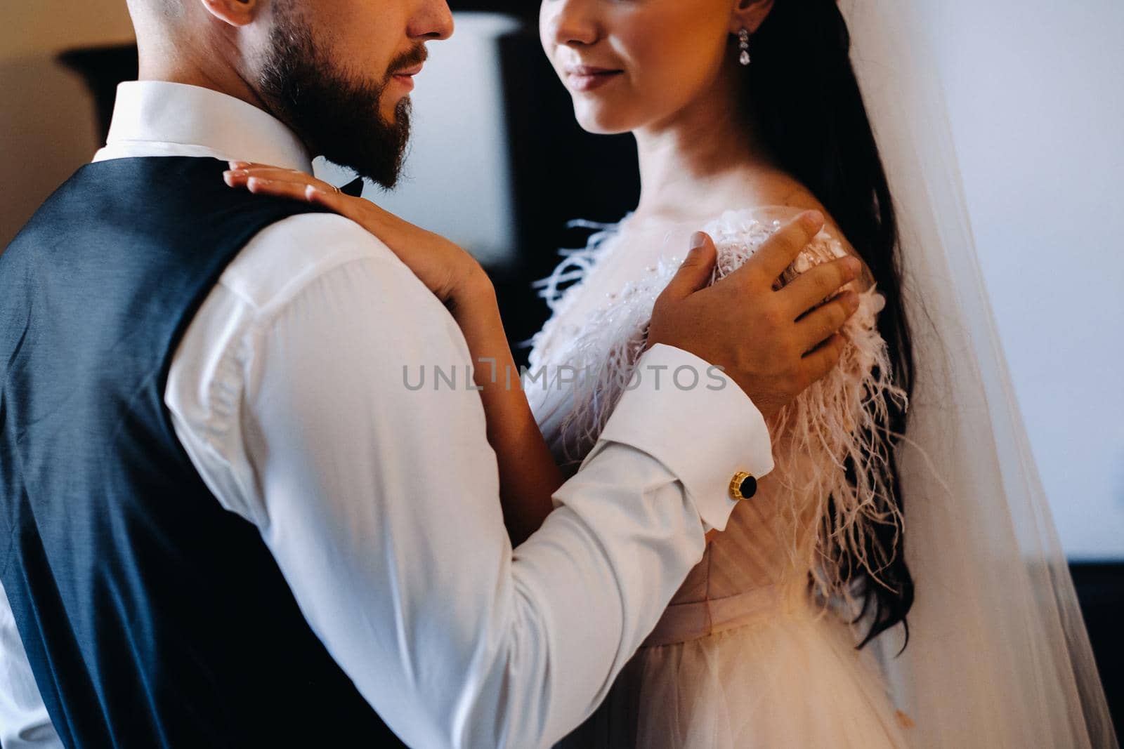 Morning of the bride. The groom stands with the bride near the mirror by Lobachad