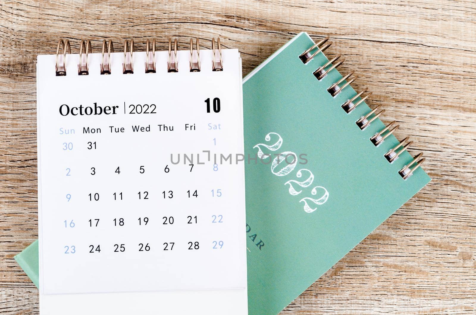 The October calendar 2022 on wooden background.