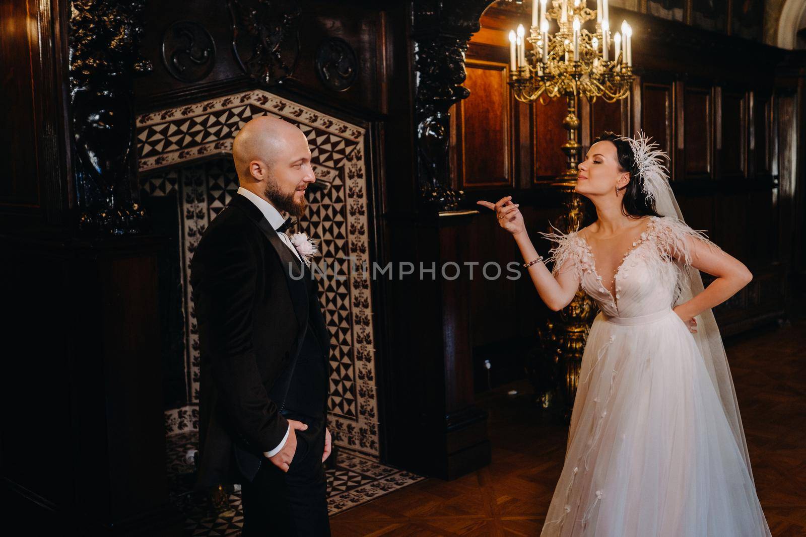 Elegant wedding couple in the interior of the old castle in the city of Nesvizh.