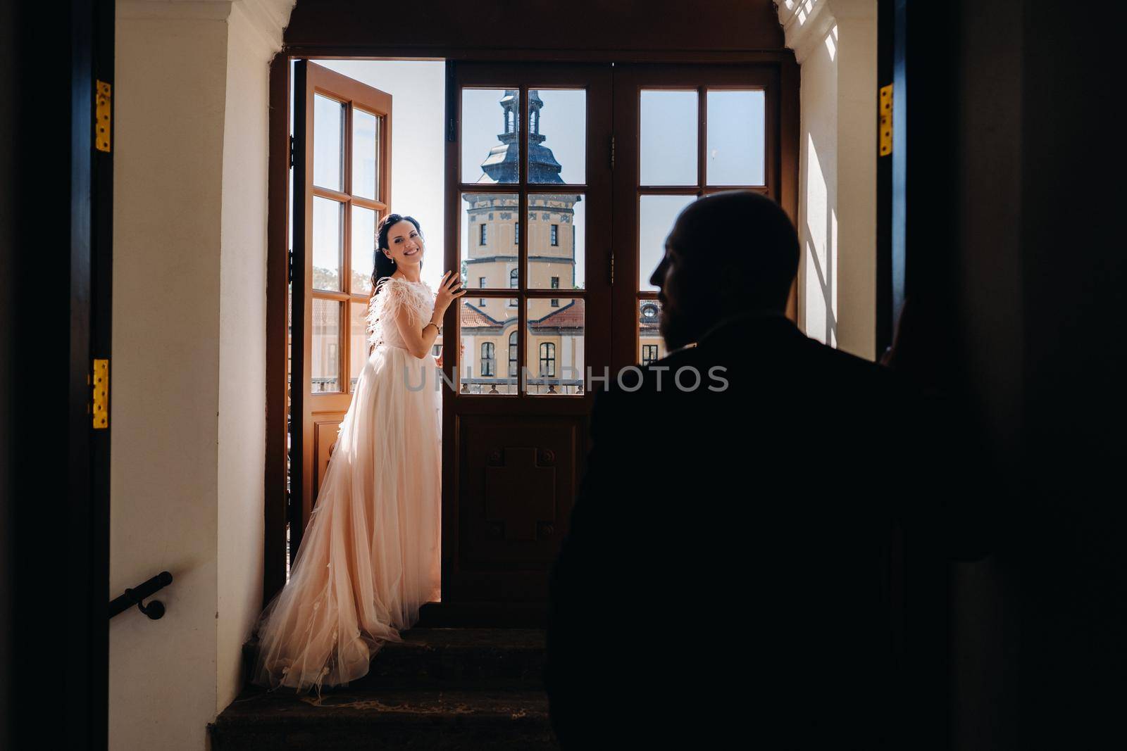 Elegant wedding couple on the balcony of an old castle in the city of Nesvizh by Lobachad
