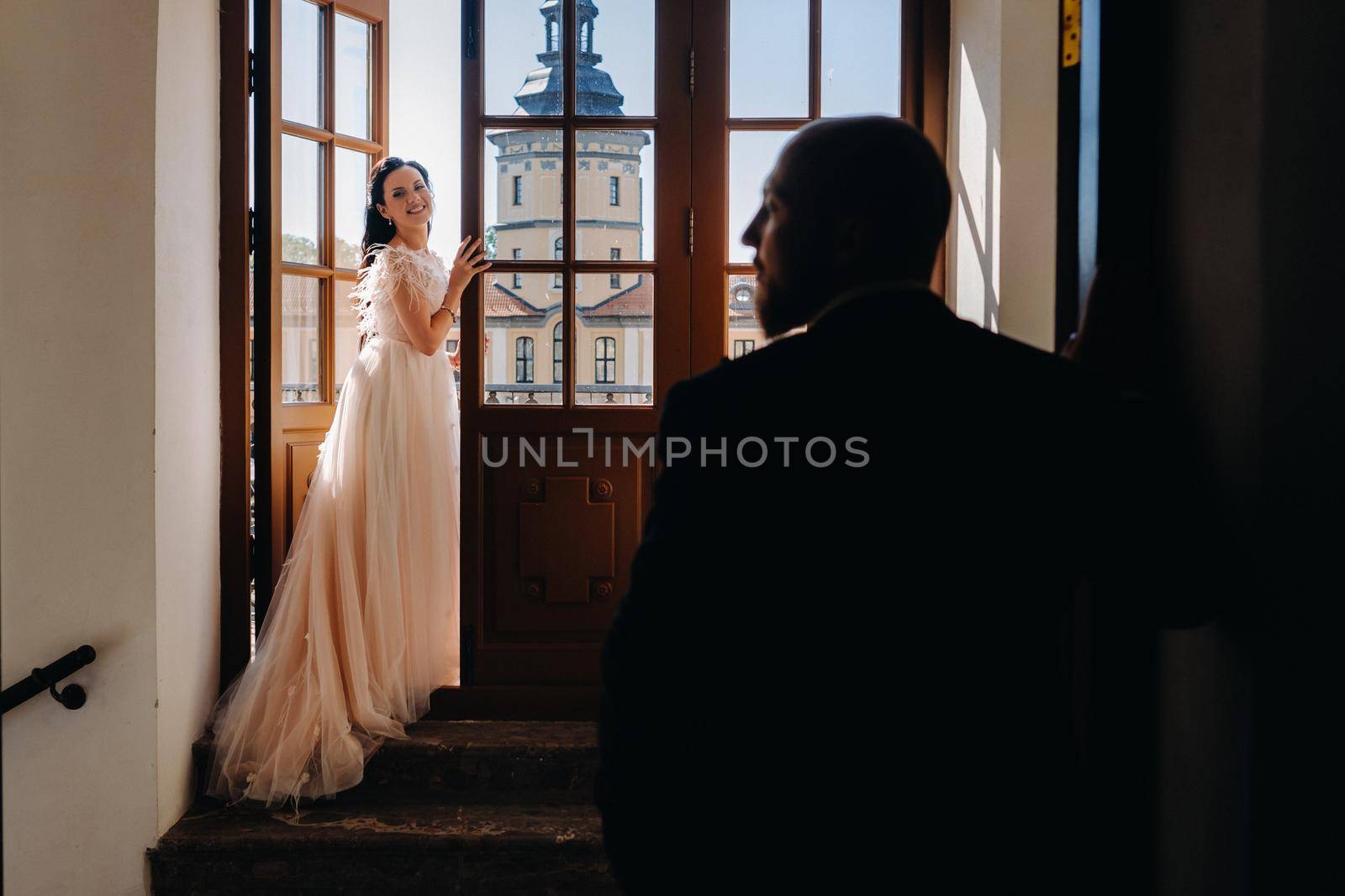 Elegant wedding couple on the balcony of an old castle in the city of Nesvizh.