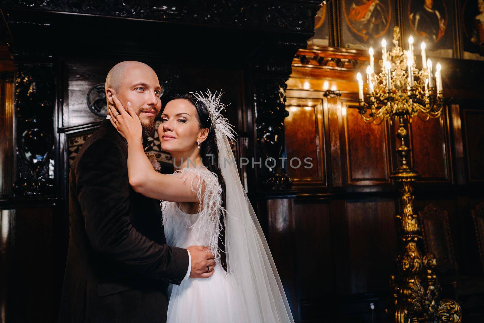 Elegant wedding couple in the interior of the old castle in the city of Nesvizh by Lobachad
