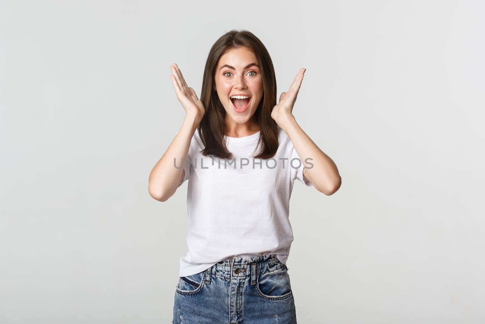 Excited happy young woman rejoicing from good news, smiling cheerful.