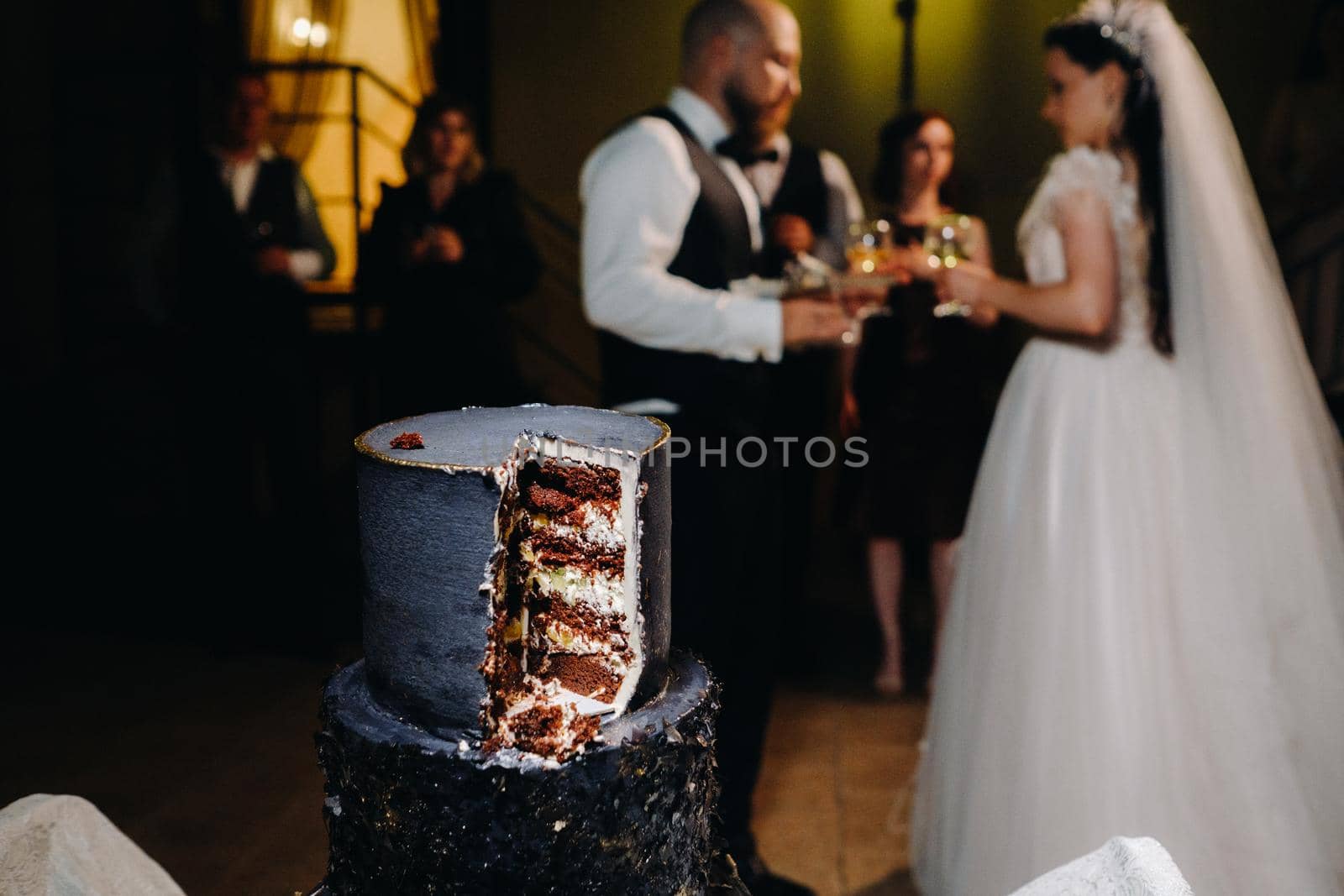A close-up cut of a wedding cake at a wedding.