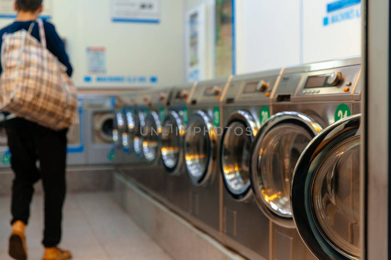 Iaundry machines in laundromat. by RecCameraStock