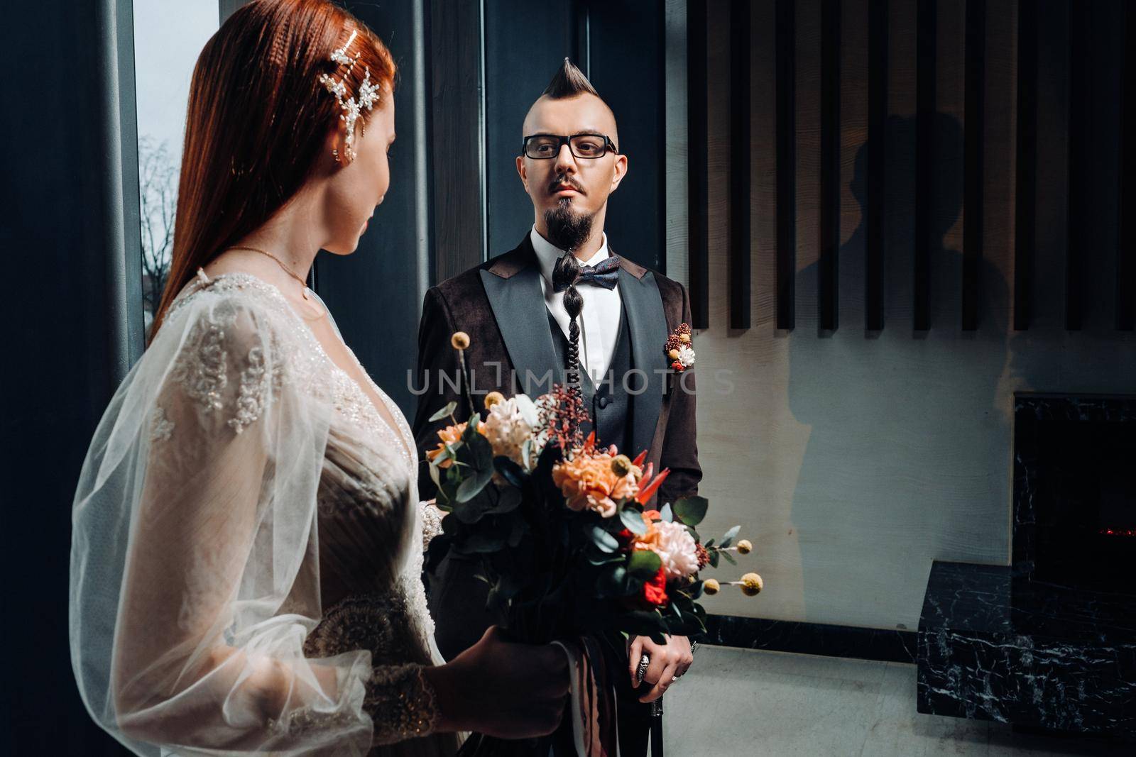 Stylish wedding couple in the interior. Glamorous bride and groom.