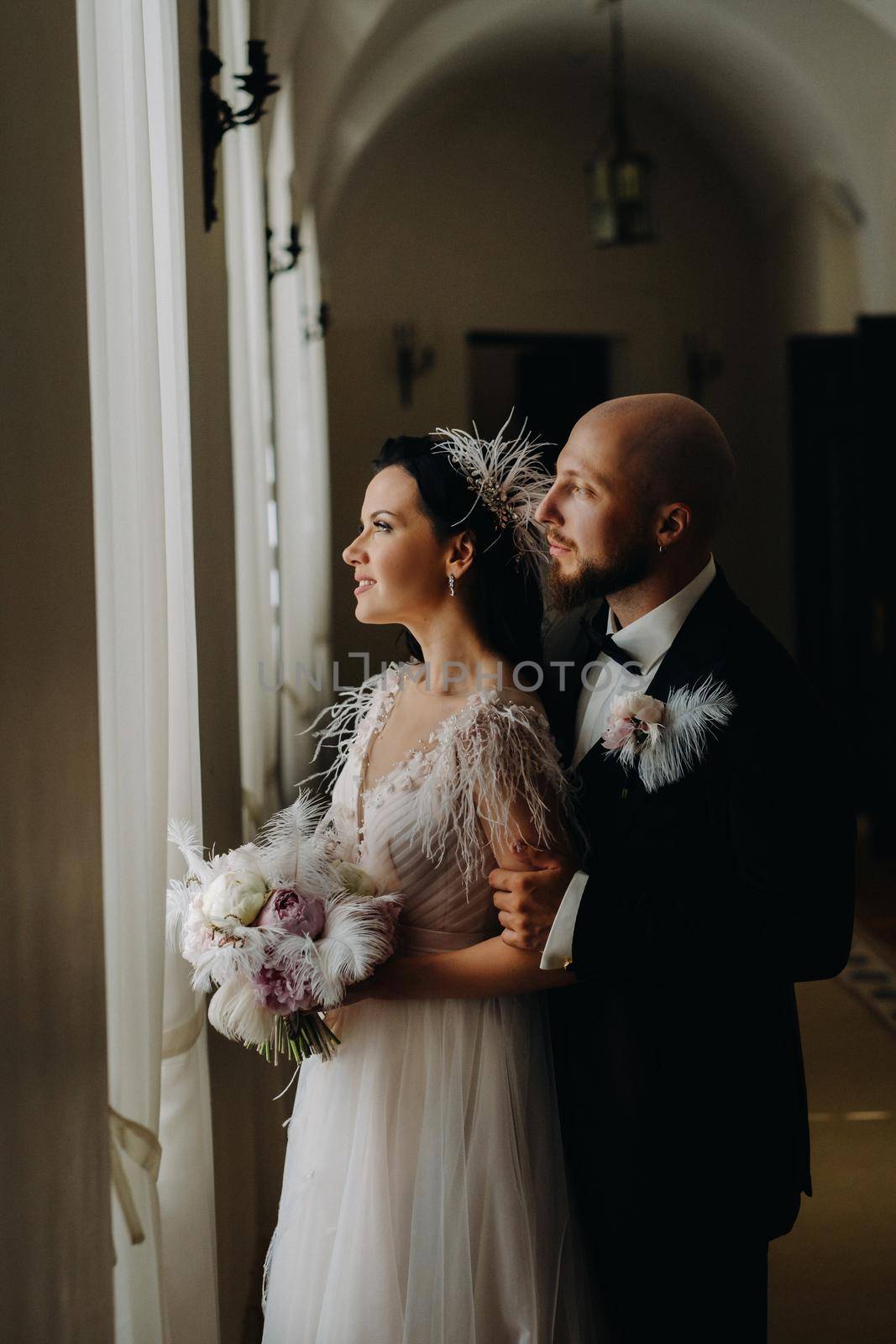 Elegant wedding couple in the interior of the old castle in the city of Nesvizh.