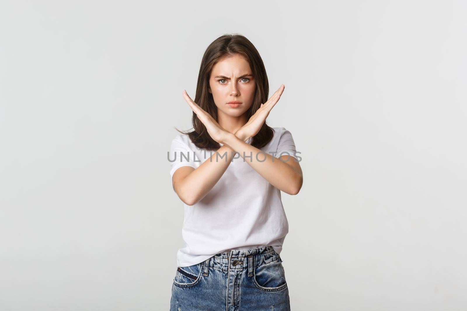 Serious angry woman showing cross, stop something bad, express disapproval or dislike.