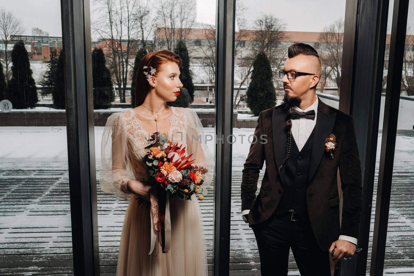 Stylish wedding couple in the interior. Glamorous bride and groom.