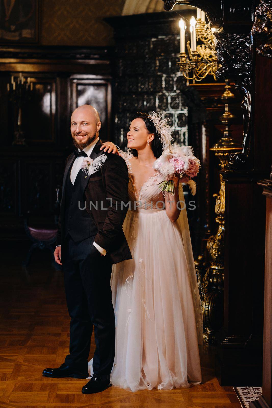 Elegant wedding couple in the interior of the old castle in the city of Nesvizh.