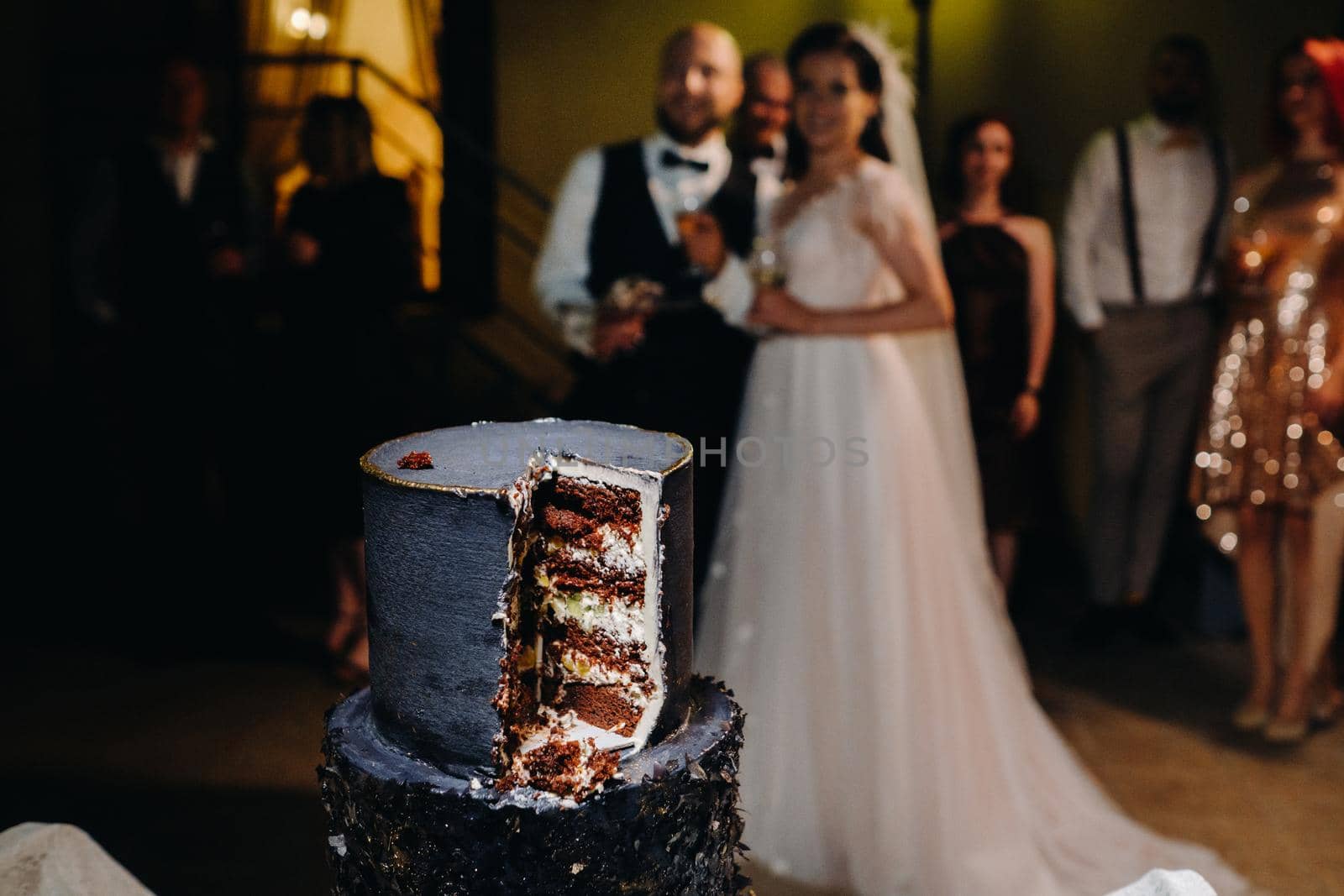 A close-up cut of a wedding cake at a wedding.