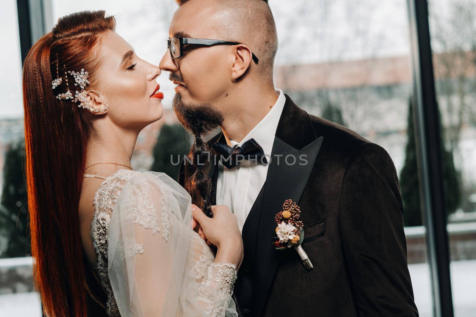 Stylish wedding couple in the interior. Glamorous bride and groom by Lobachad