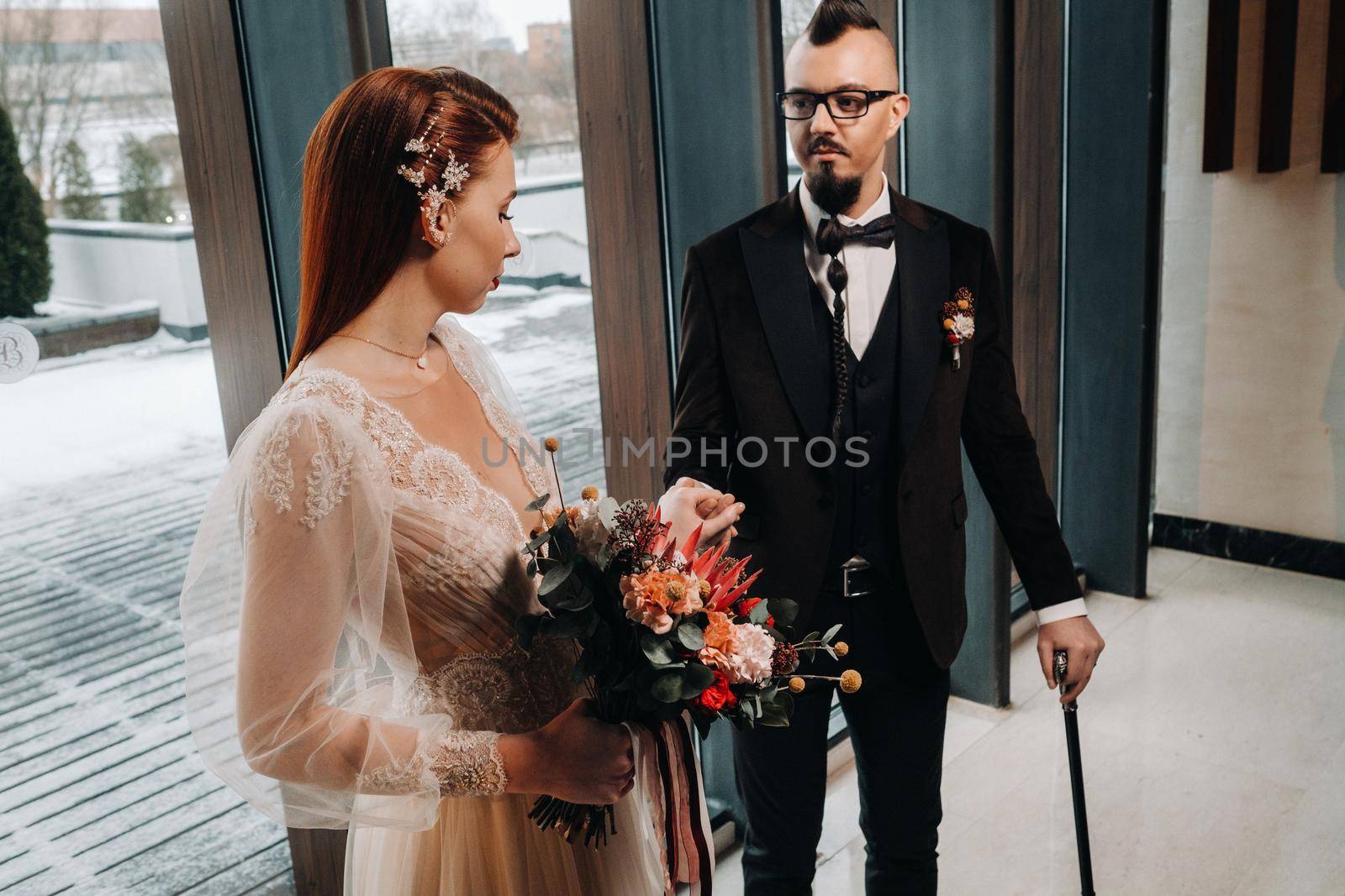 Stylish wedding couple in the interior. Glamorous bride and groom.