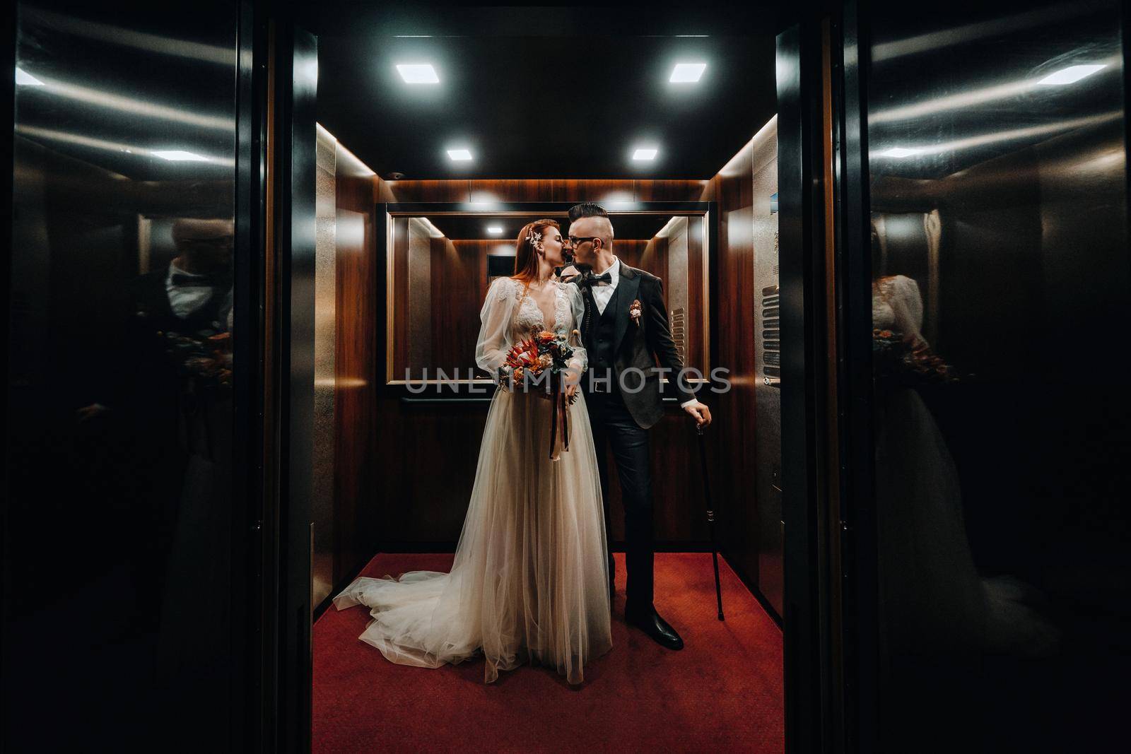 Stylish wedding couple in the interior. Glamorous bride and groom.