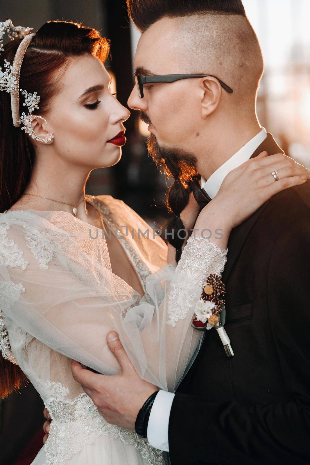 Stylish wedding couple in the interior. Glamorous bride and groom.