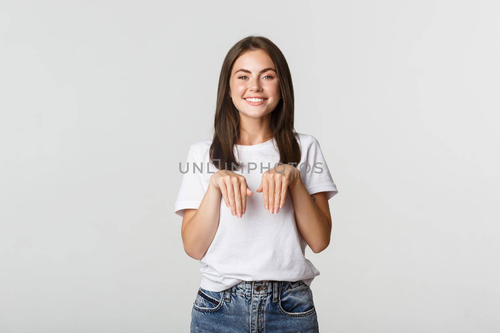Silly and cute brunette girl smiling and standing in puppy pose.