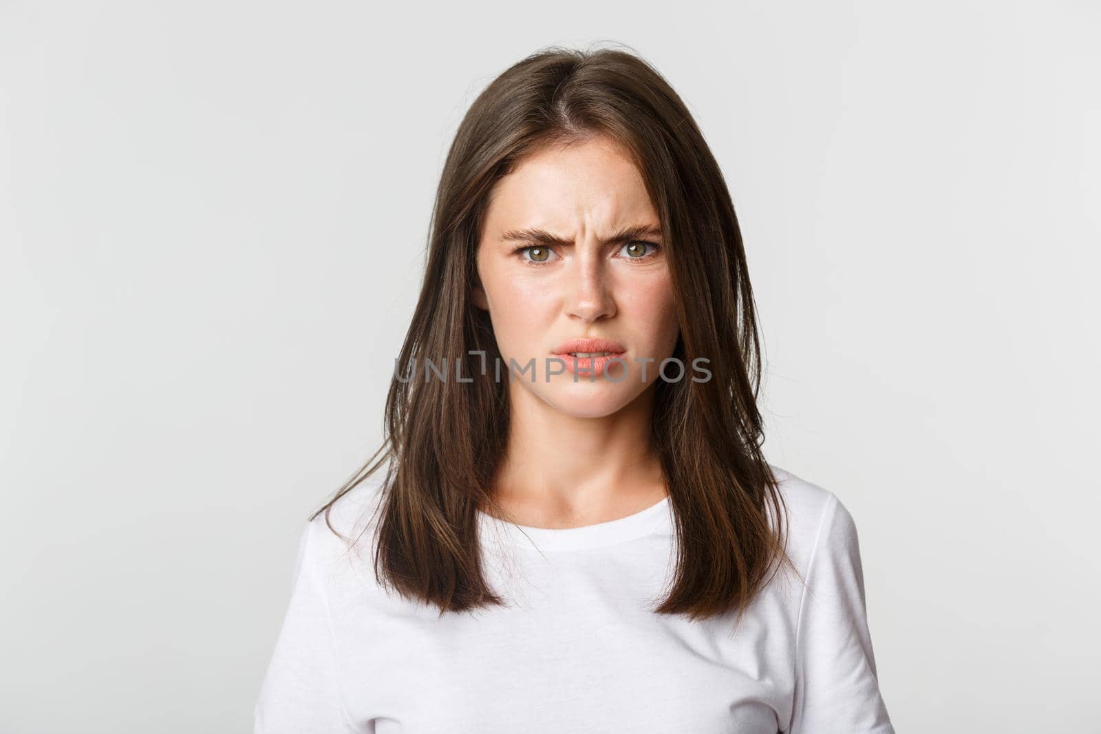 Close-up of skeptical and displeased attractive girl shaking head in rejection, frowning disappointed.