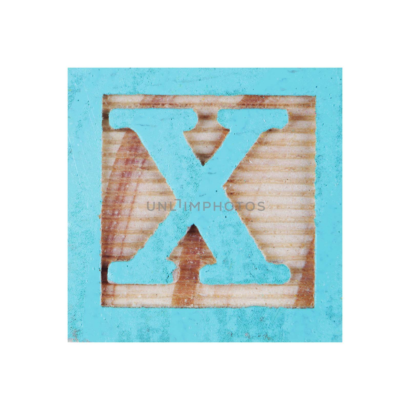 A letter X childs wood block on white with clipping path