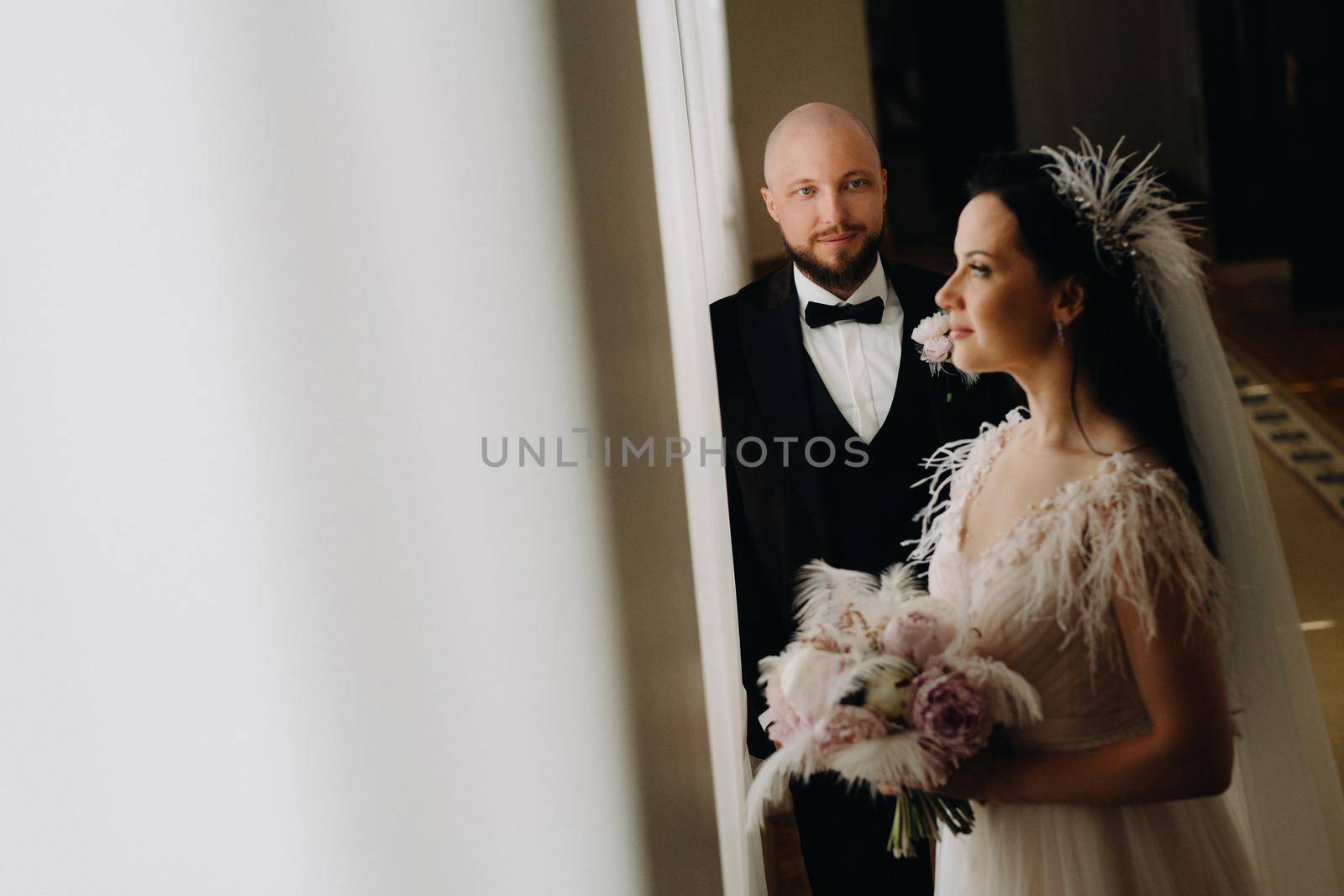 Elegant wedding couple in the interior of the old castle in the city of Nesvizh.